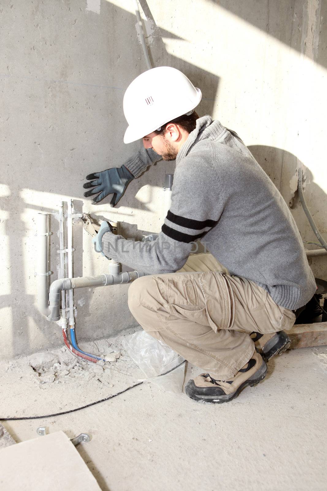 Plumber working on a site