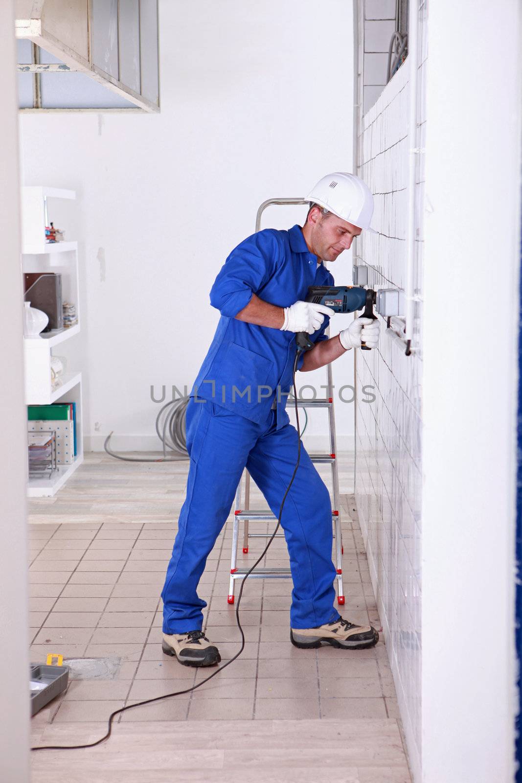 Tradesman using a power drill