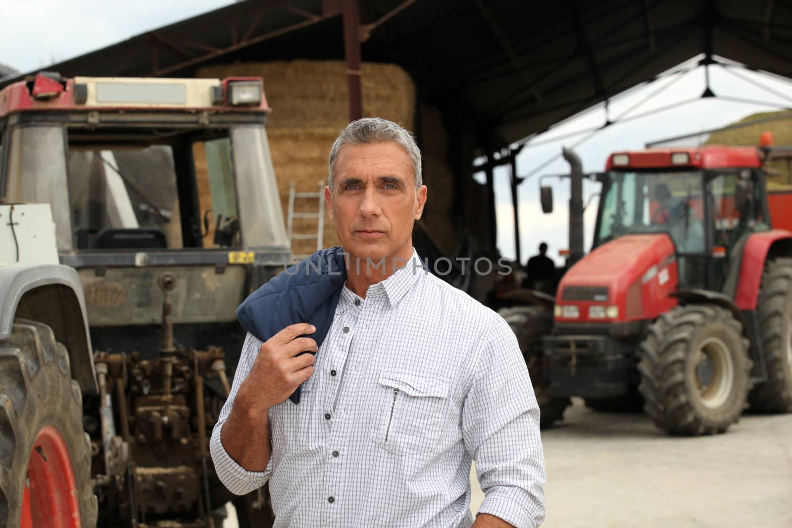 A farmer posing with his tractors