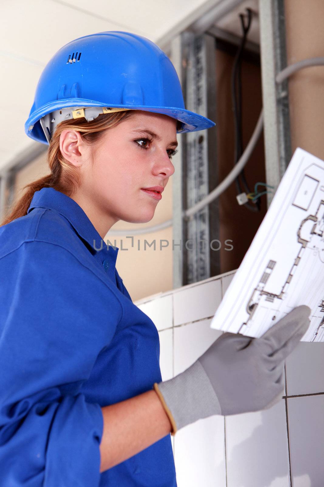 Female electrician with diagram