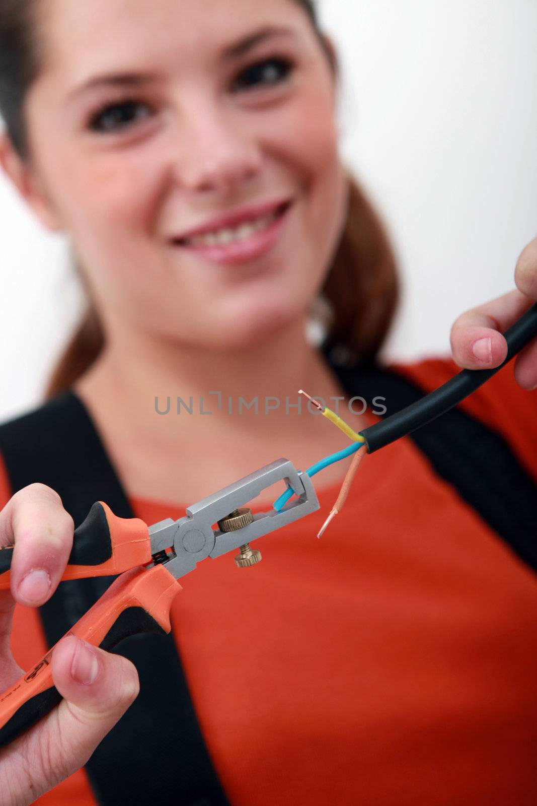 female electrician using wire cutter