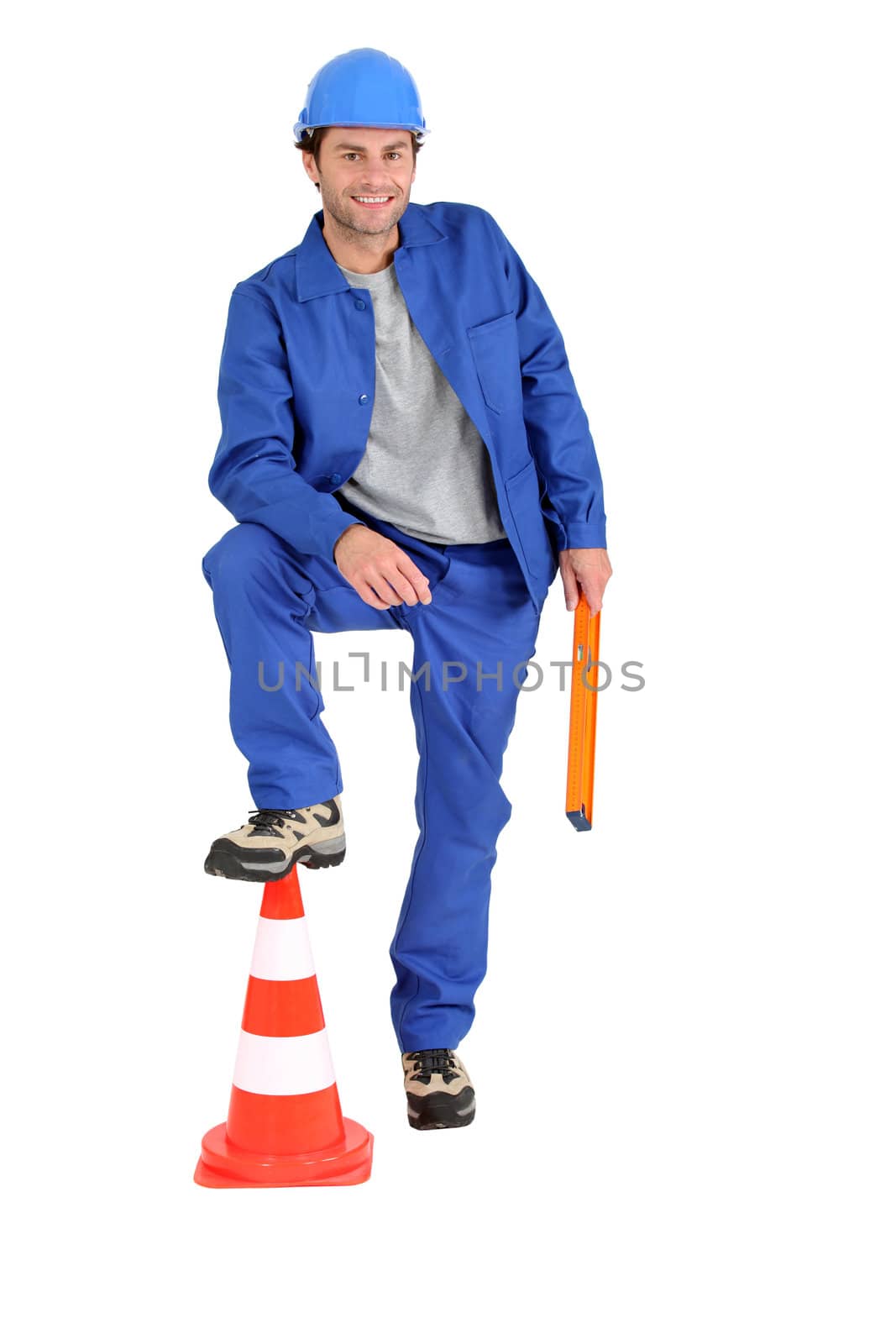 Builder with foot on cone.