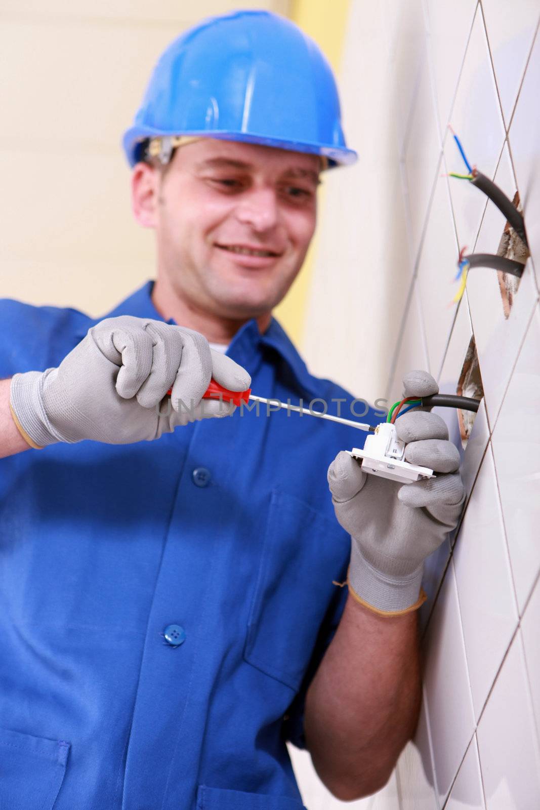 Electrician wiring a continental wall socket