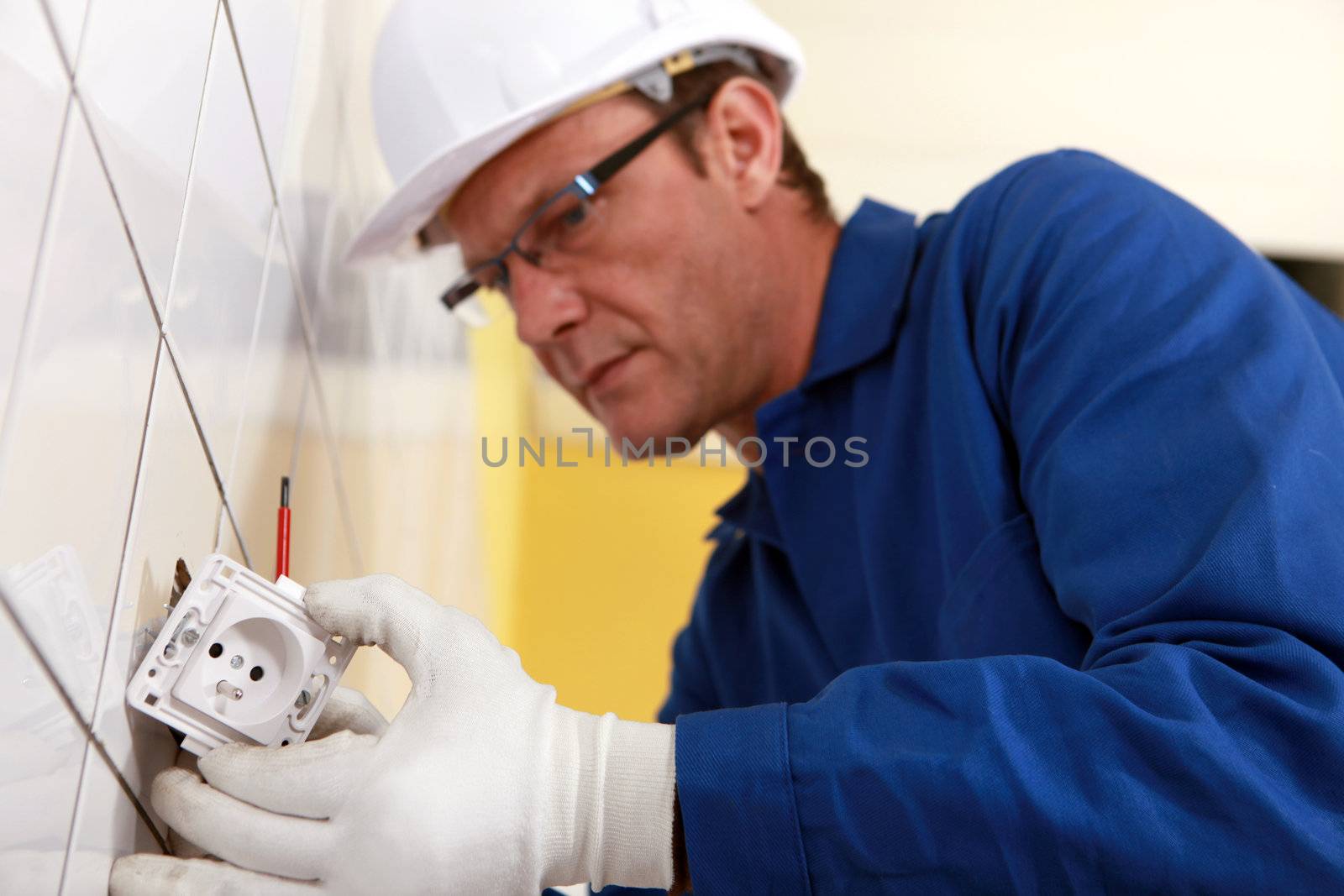 Electrical engineer fixing socket