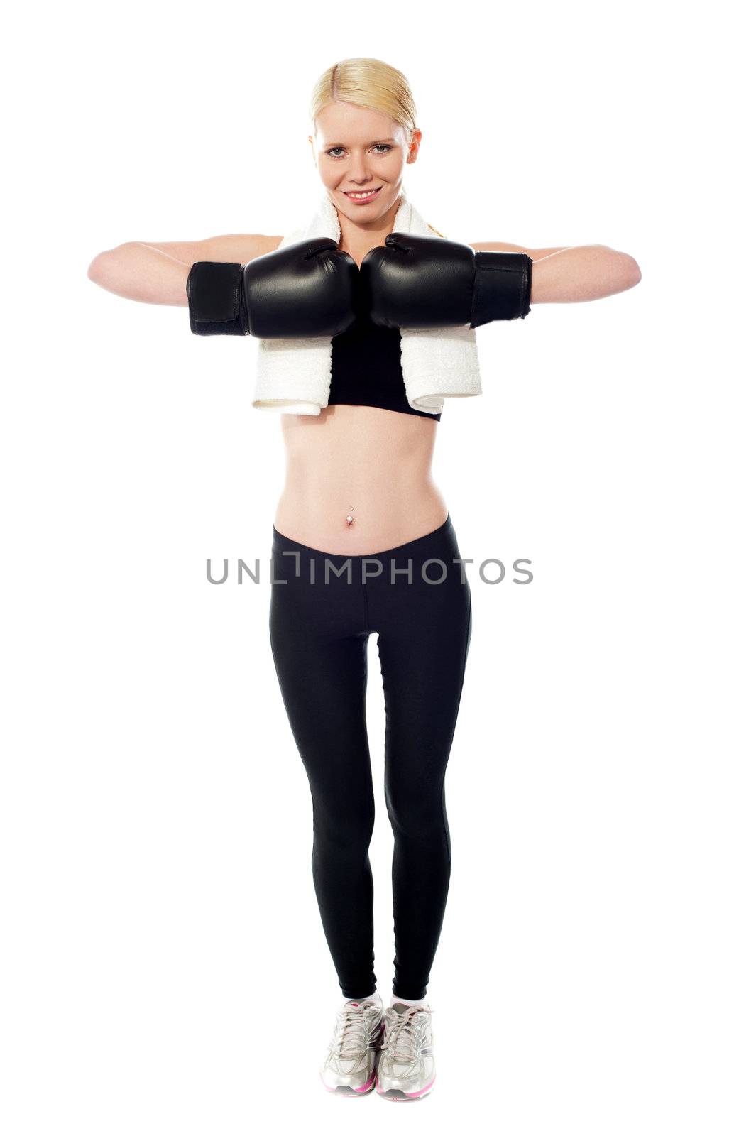 Happy female boxer posing with gloves on. Towel around her neck