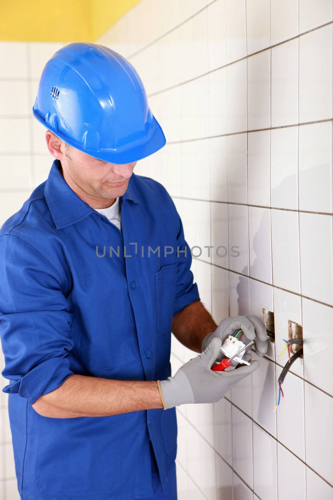 electrician connecting an electrical outlet