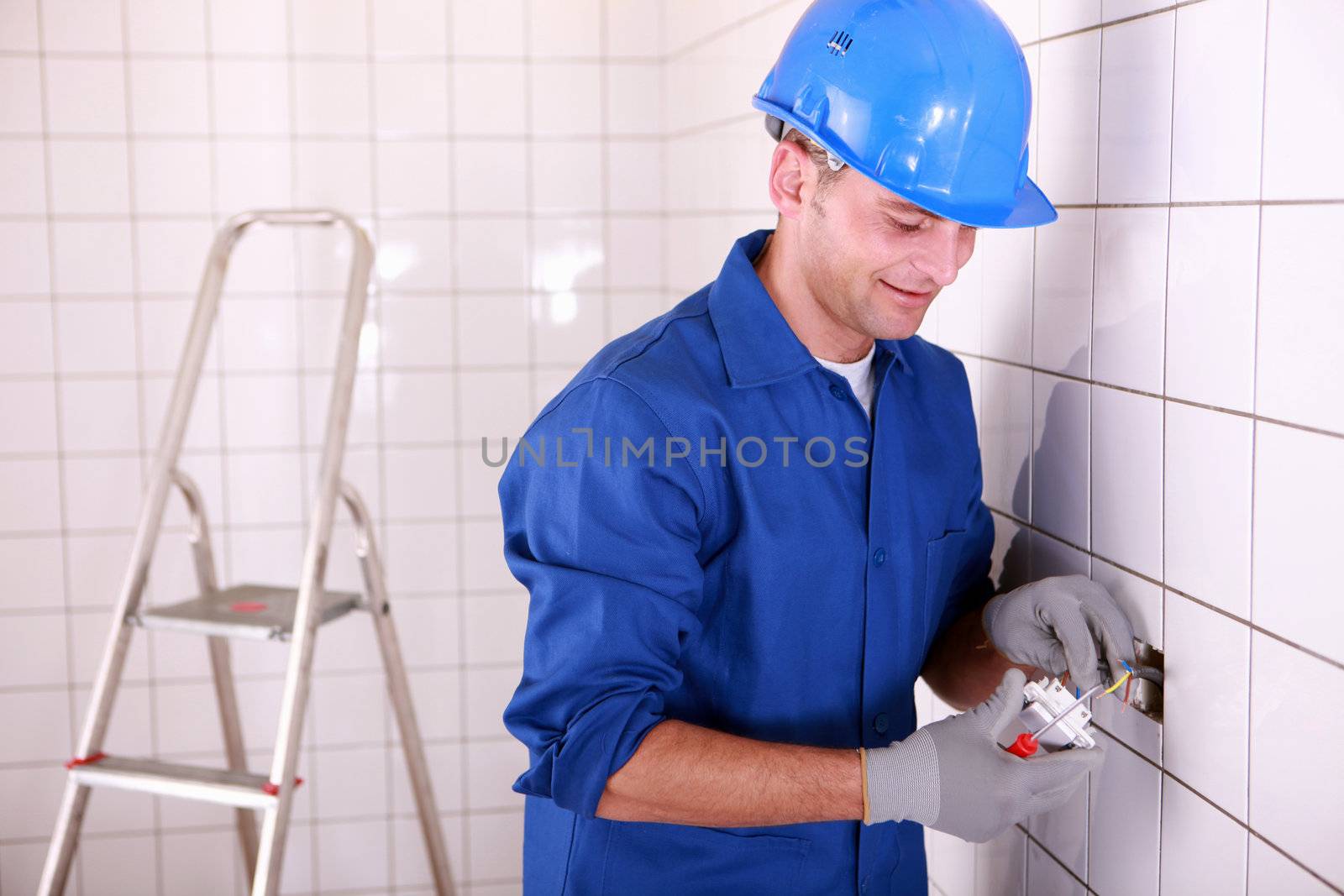 Electrician fitting a light switch