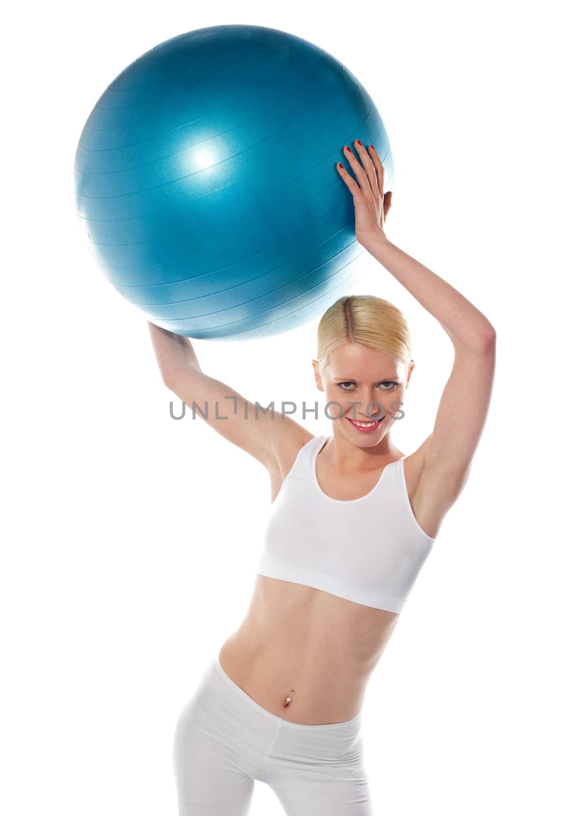 Female athlete holding blue ball, studio shot. Isolated over white