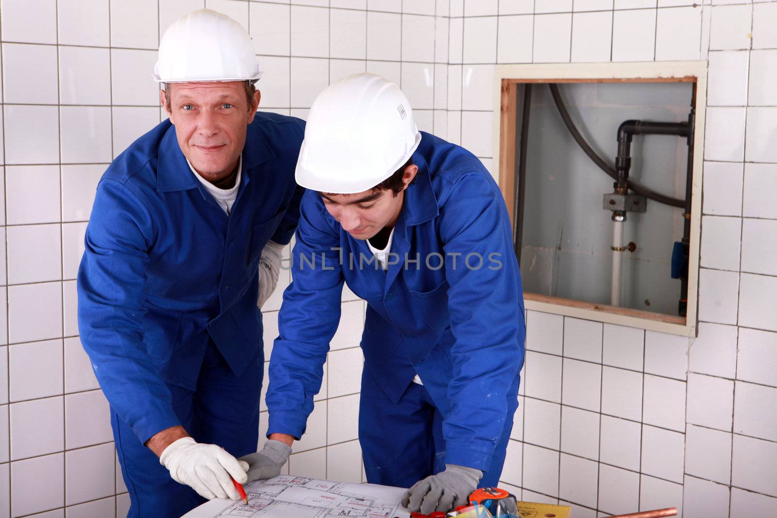 Workers reading a plan
