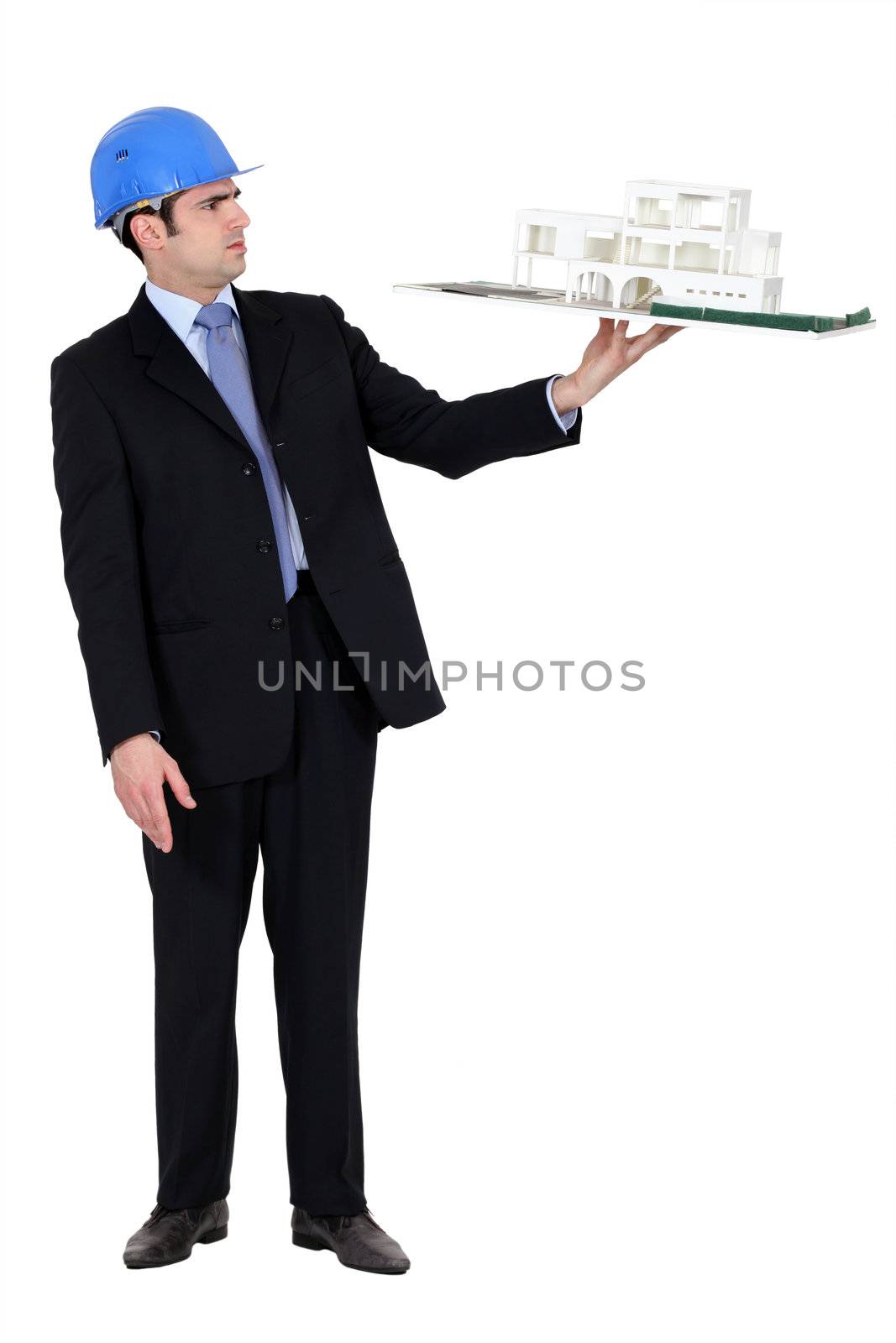 architect in suit holding model looking annoyed