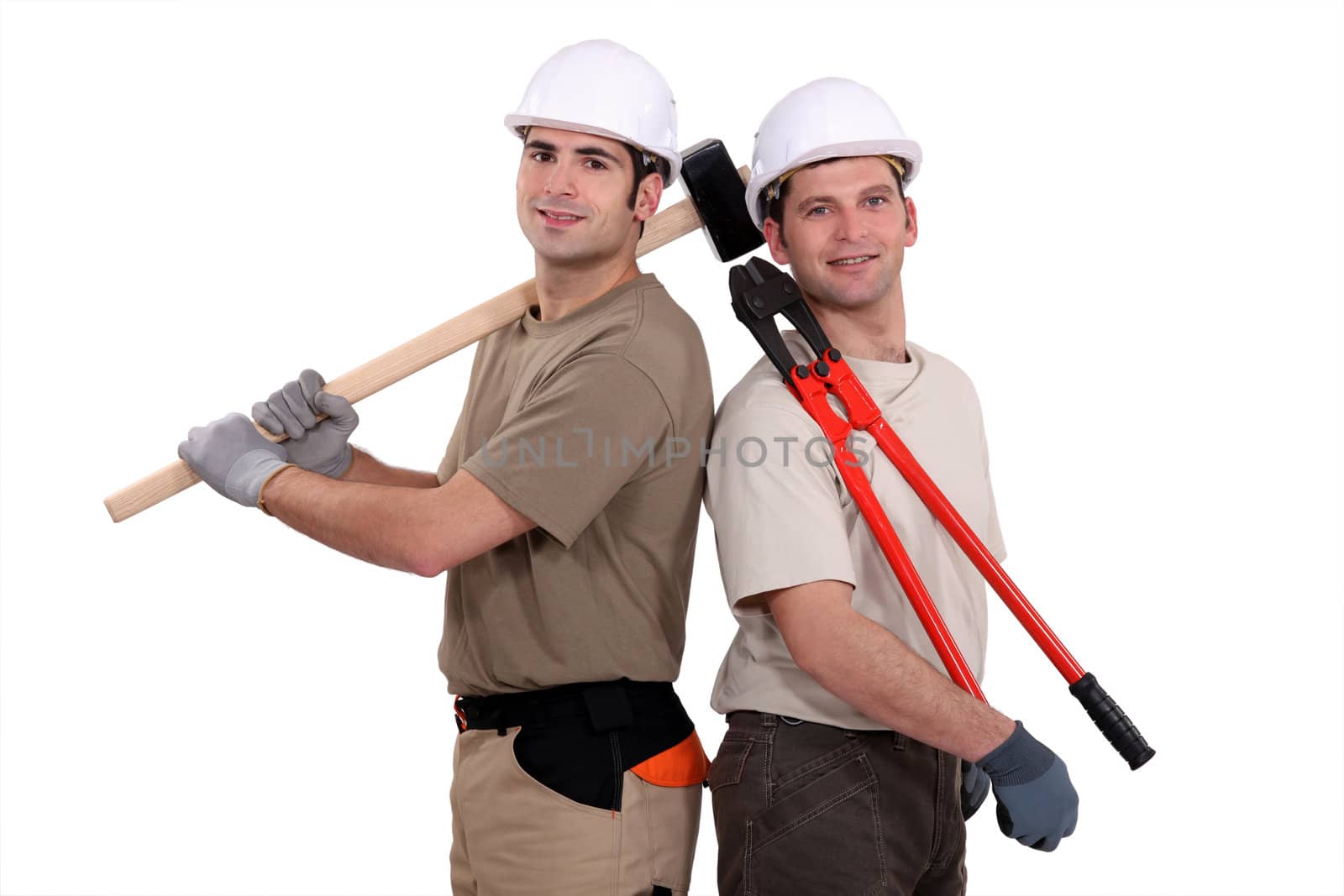 Construction worker holding heavy-duty tools by phovoir