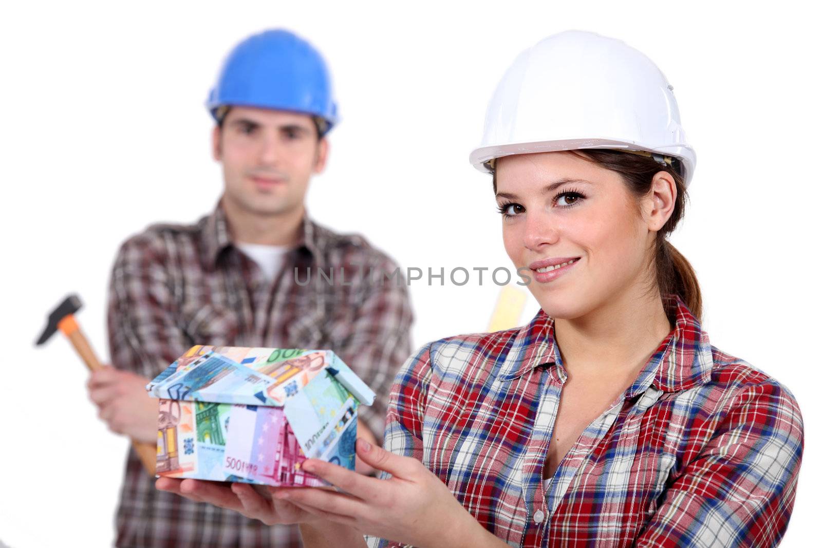 Builders with a house made of money by phovoir