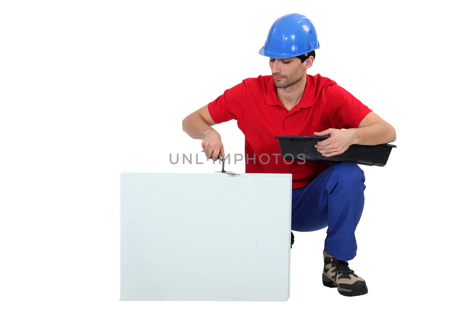 Bricklayer cementing a board left blank for your message