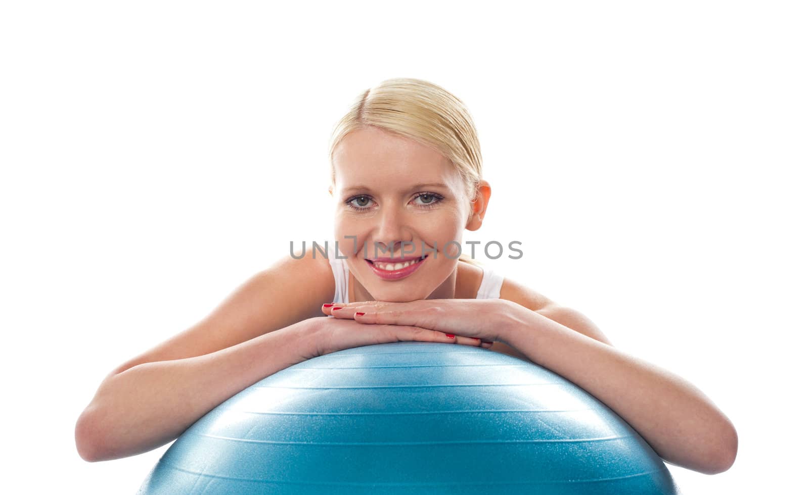 Attractive fit young woman resting chin over ball isolated against white background