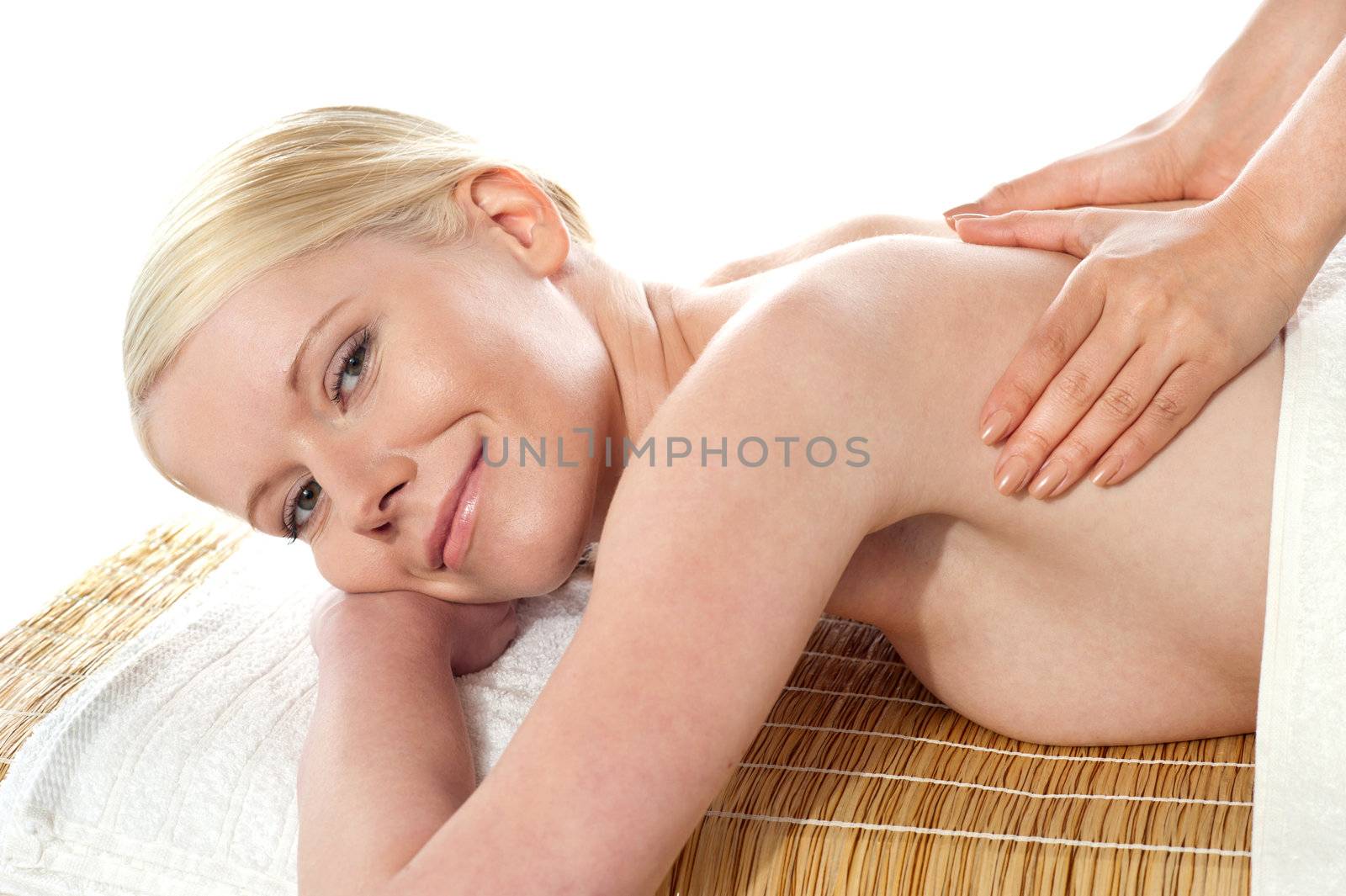 Young beautiful female getting massage from spa therapist