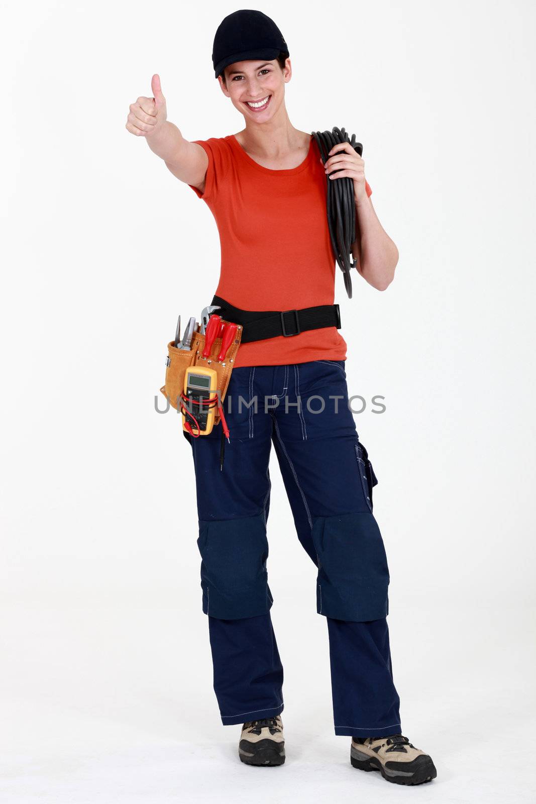 Female electrician giving thumbs-up