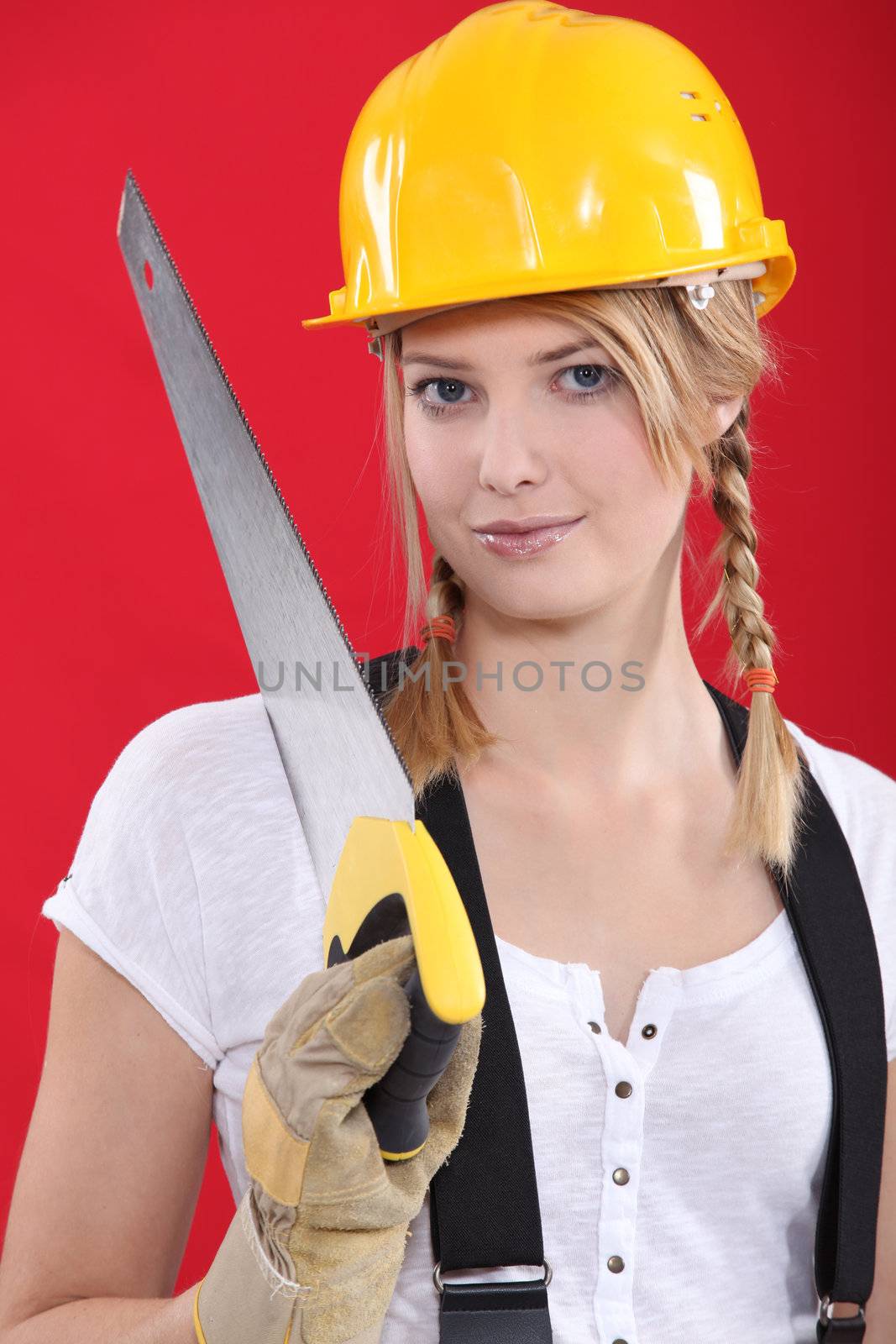 Woman with a hardhat and handsaw