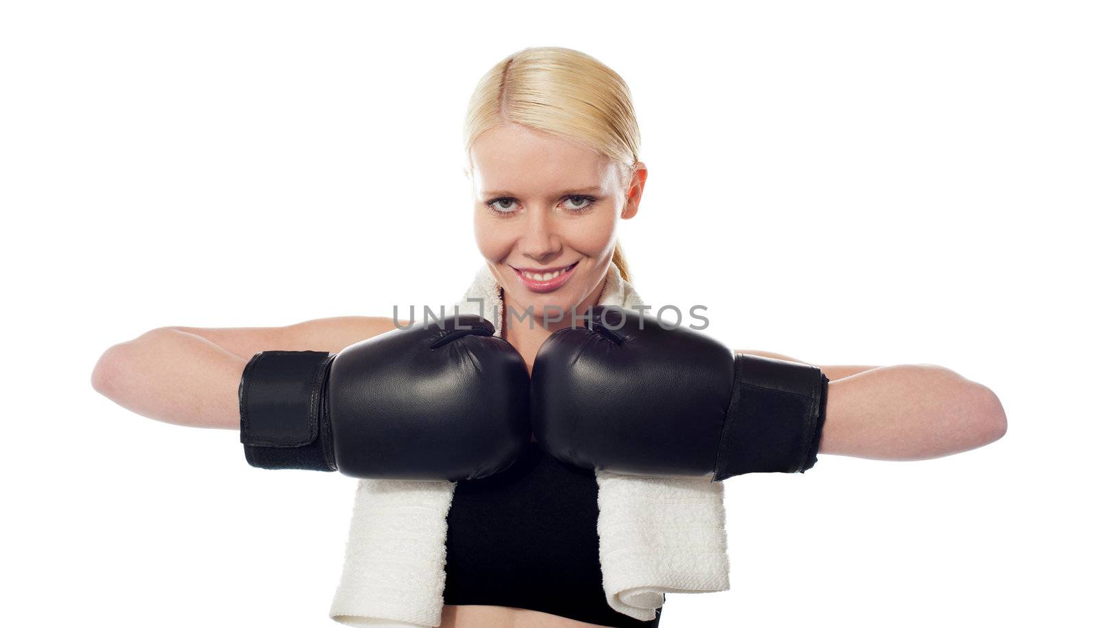Happy teenage boxer wearing black boxing gloves looking at you