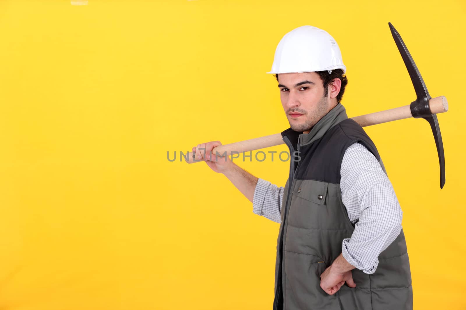 Confident worker with pick-axe