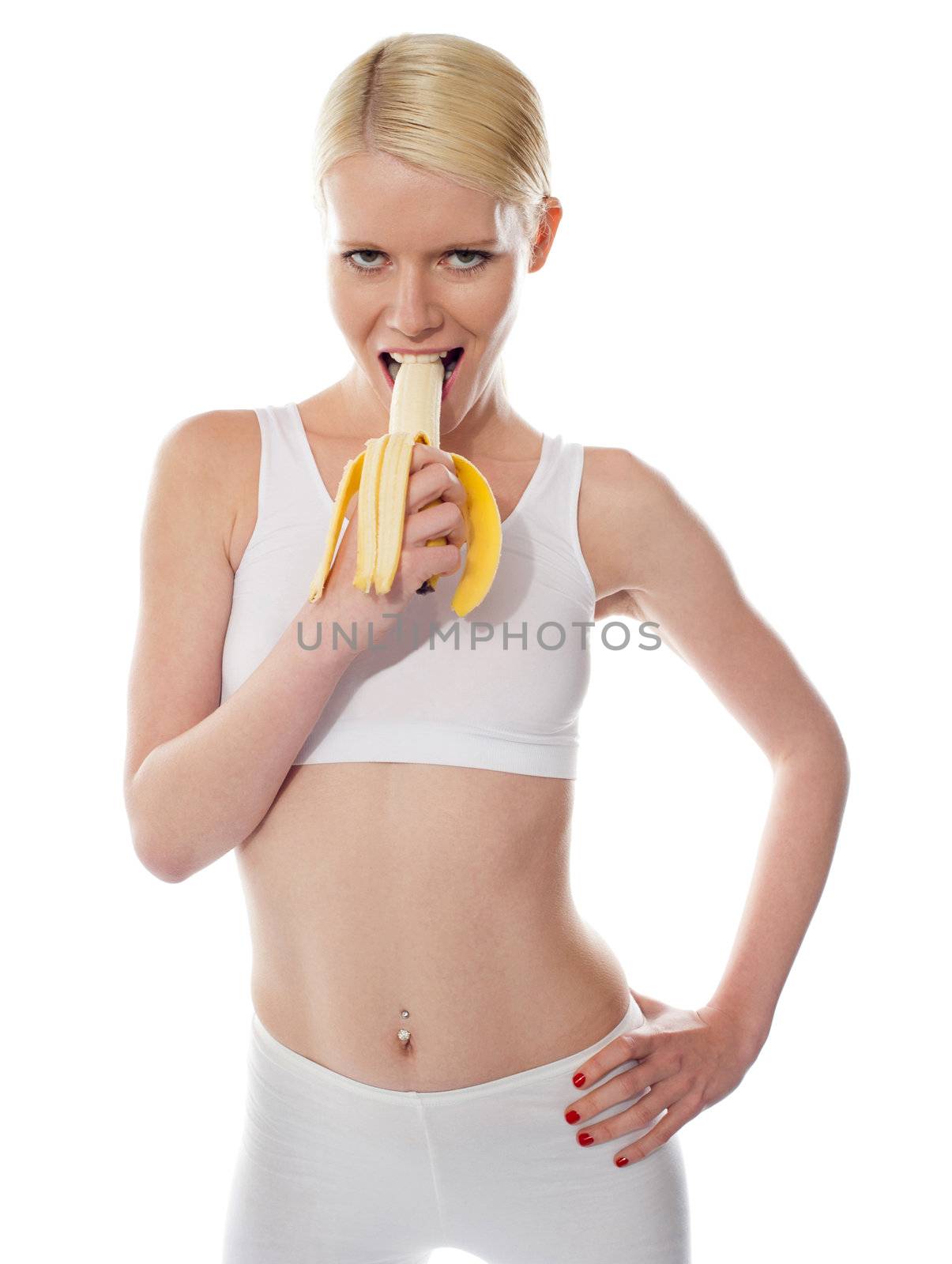 Starving sexy woman eating banana, half-peeled