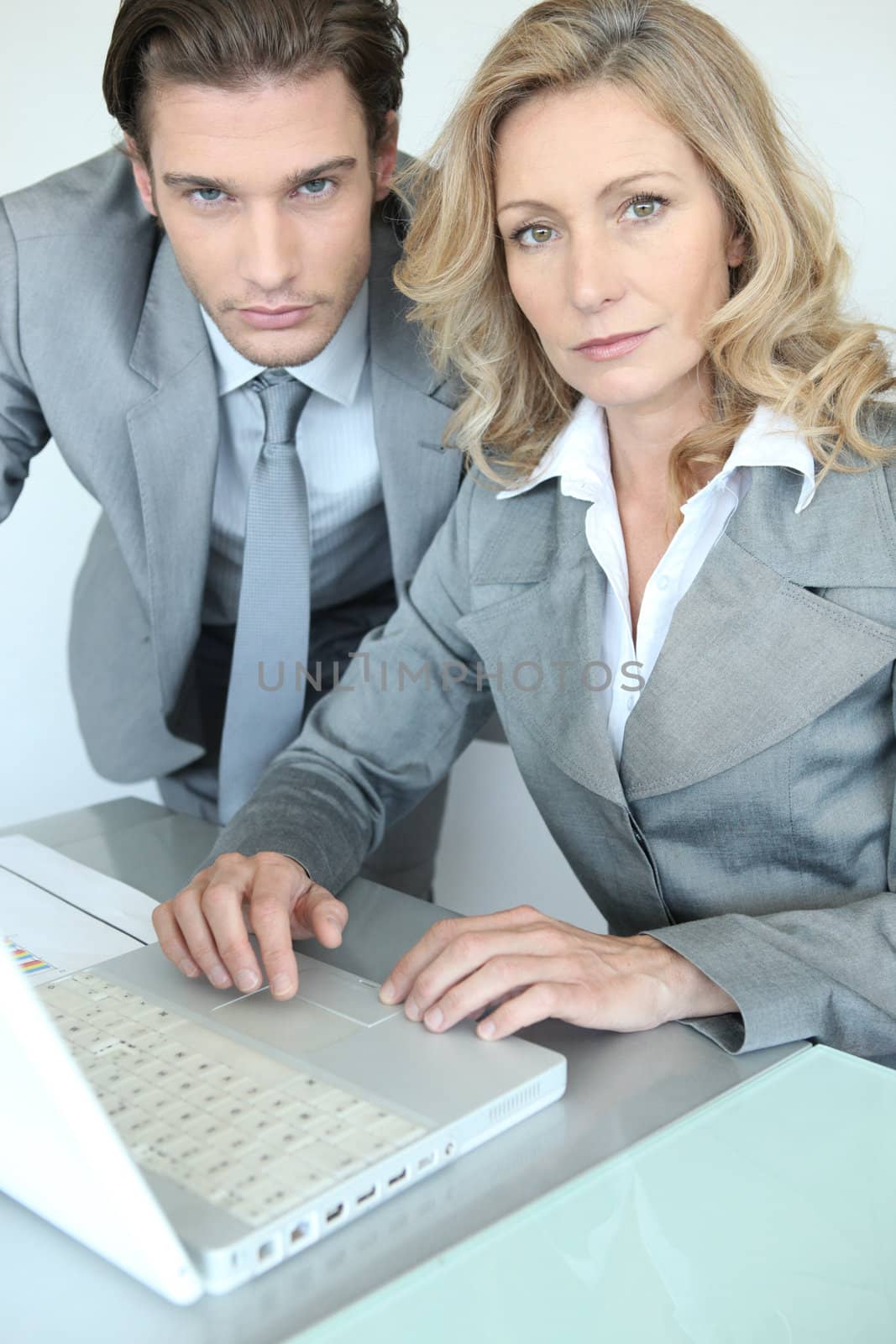 businessman and businesswoman with laptop by phovoir