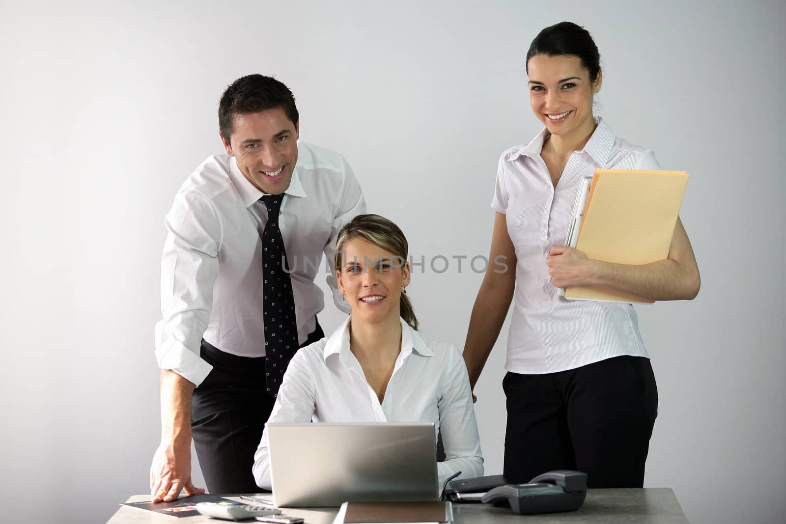 Three co-workers in office by phovoir