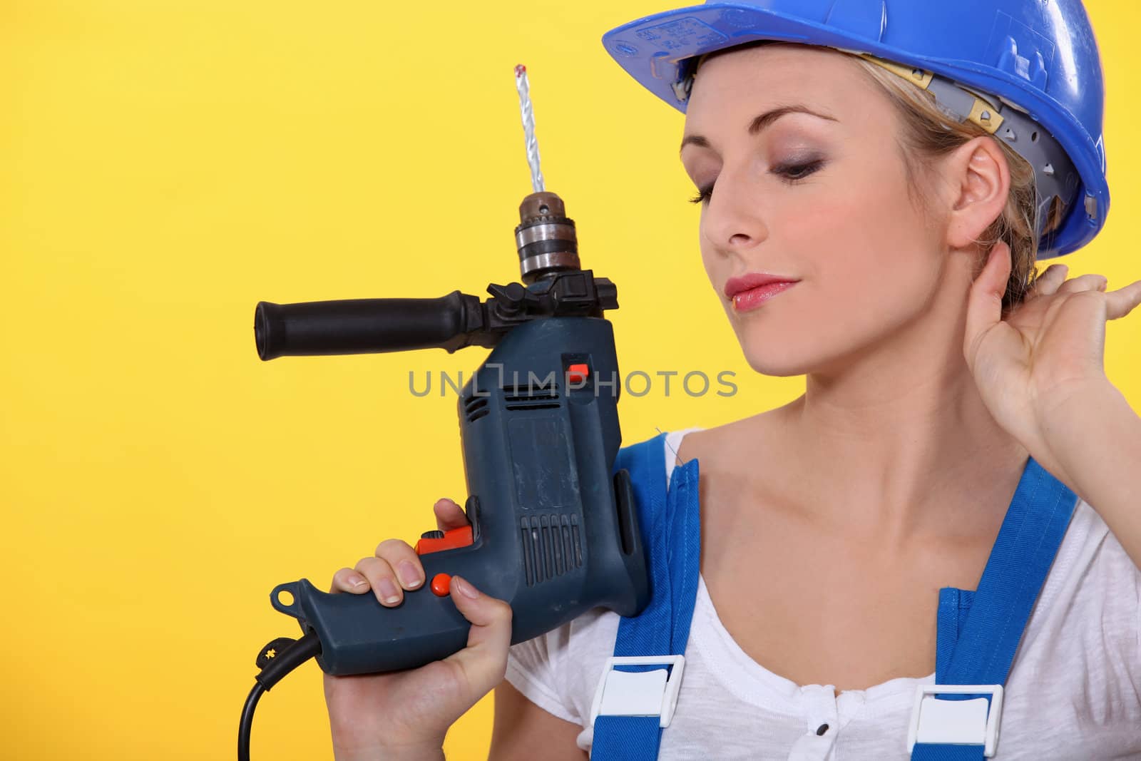 Young woman with an electric drill