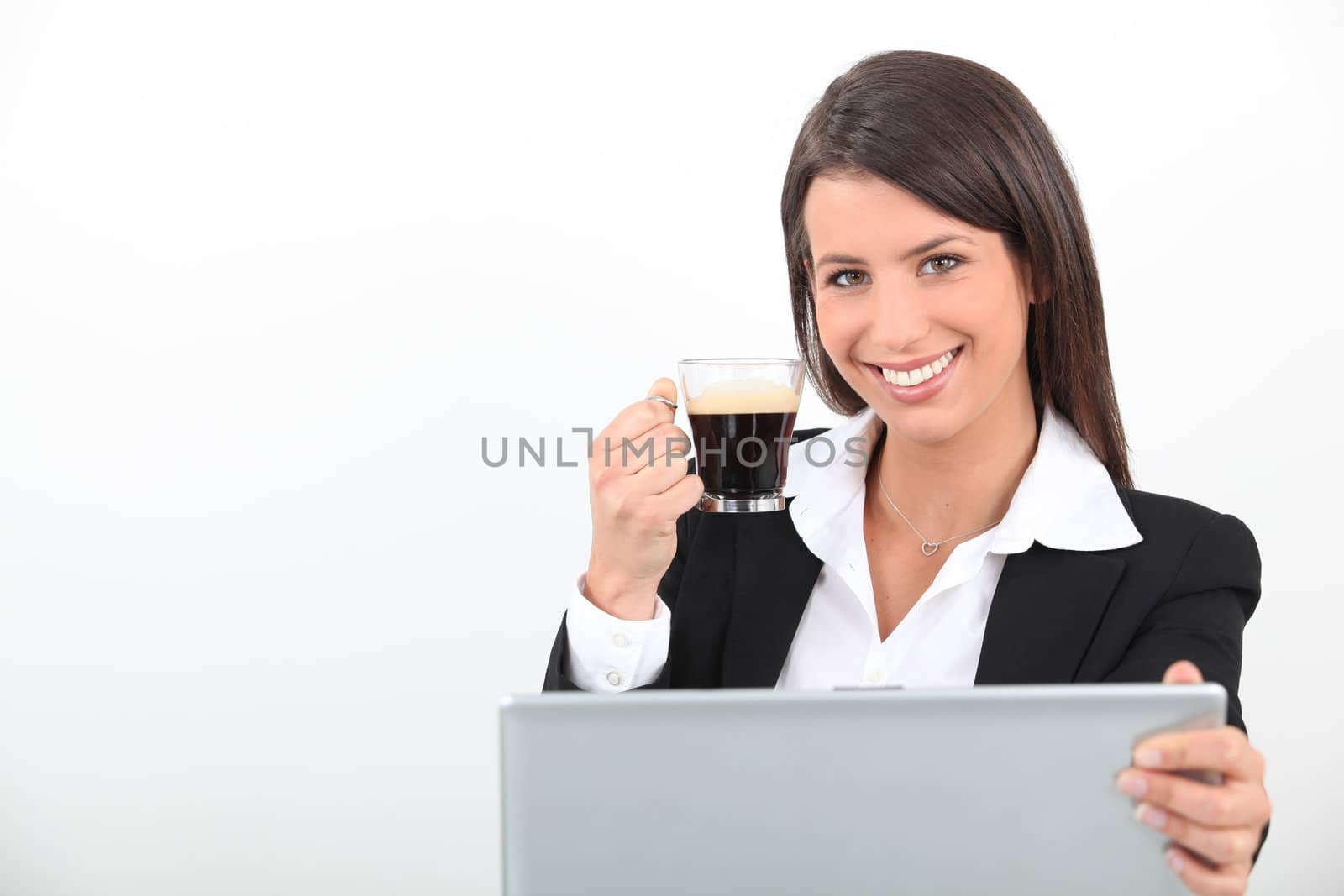 Woman drinking a coffee at her laptop