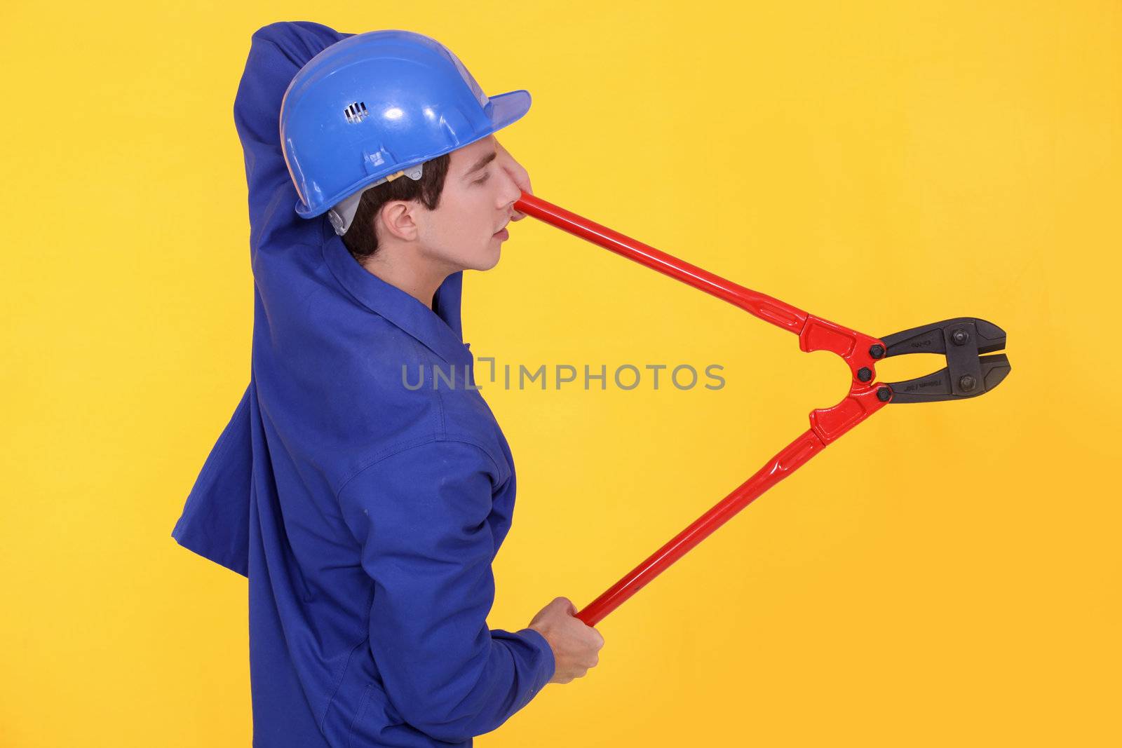 Tradesman holding large clippers