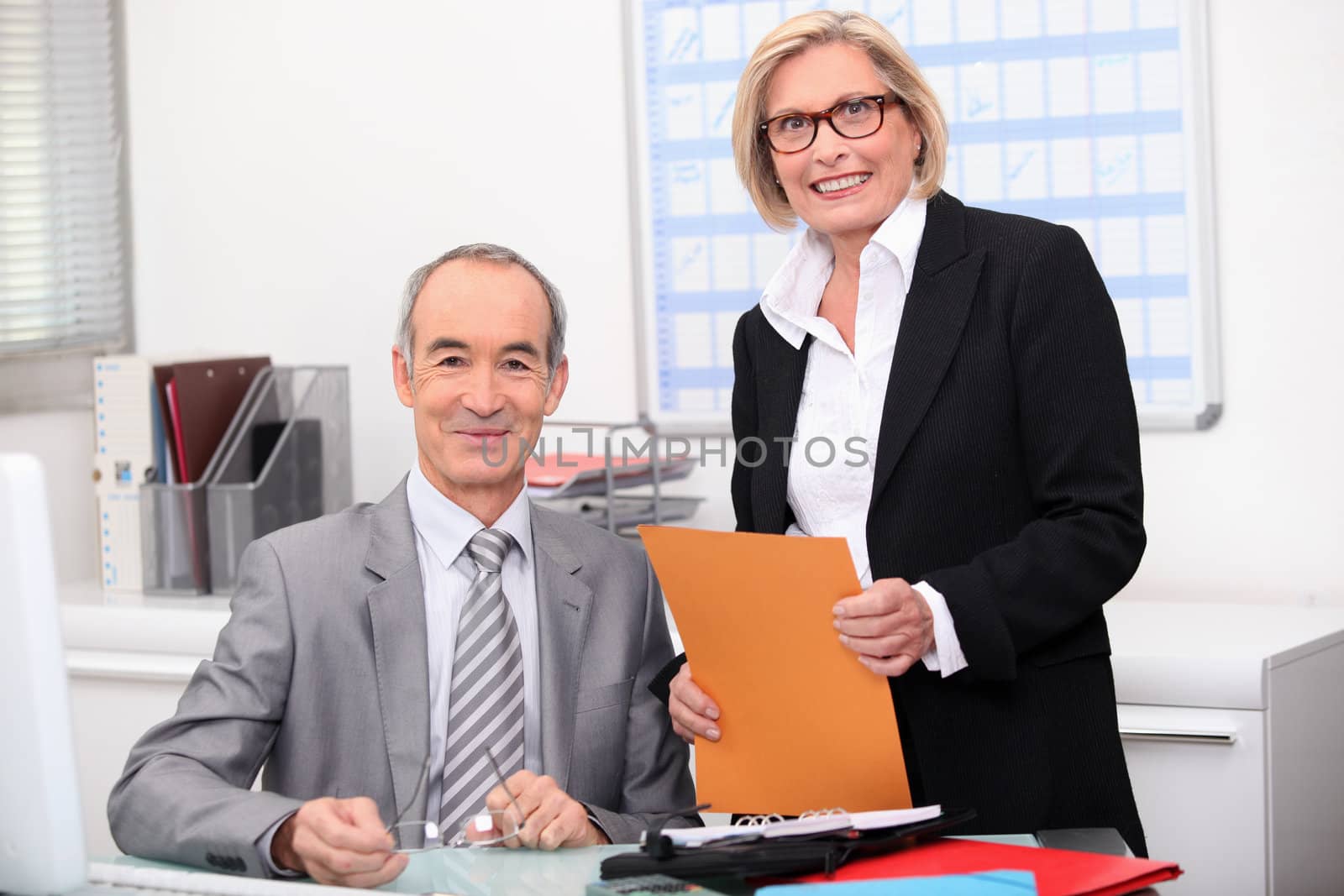 Older couple working in an office