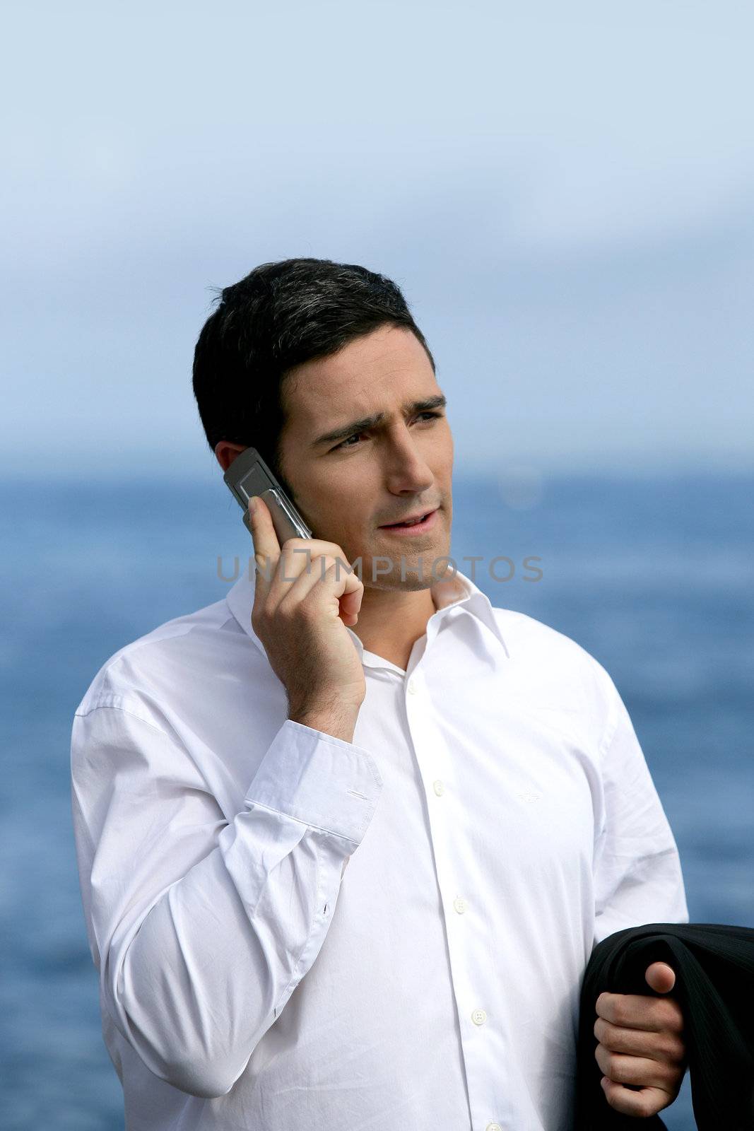 Businessman talking on his mobile phone outside