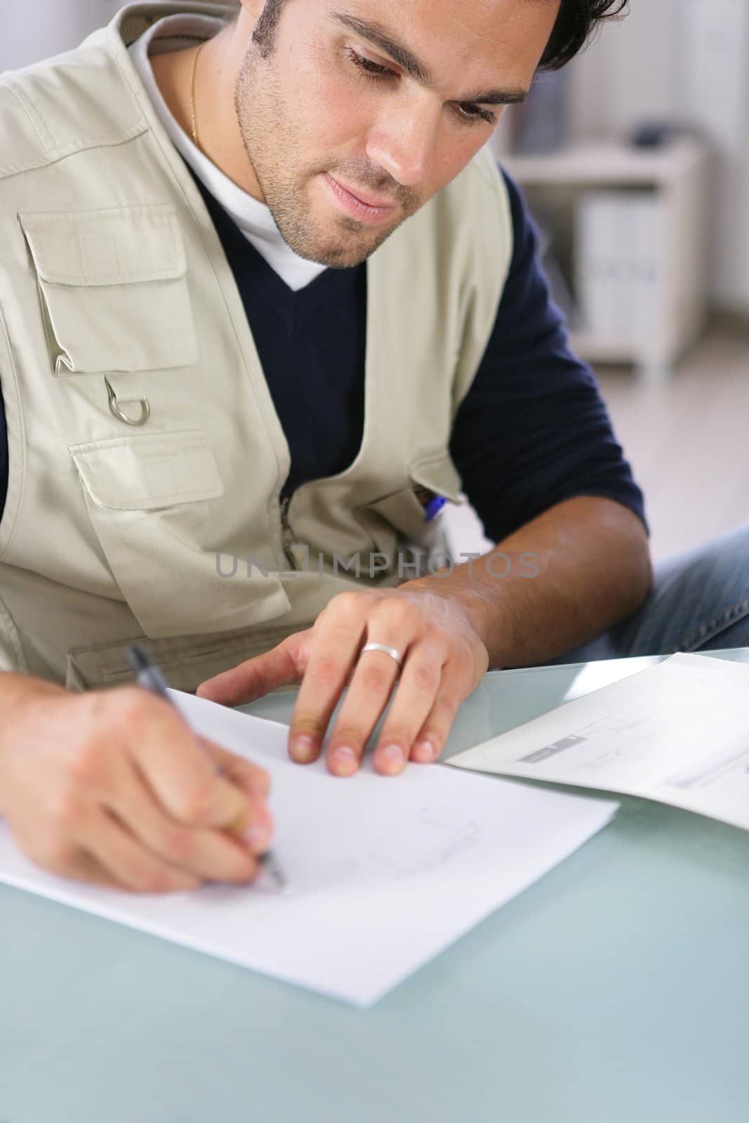 Man writing on a piece of paper