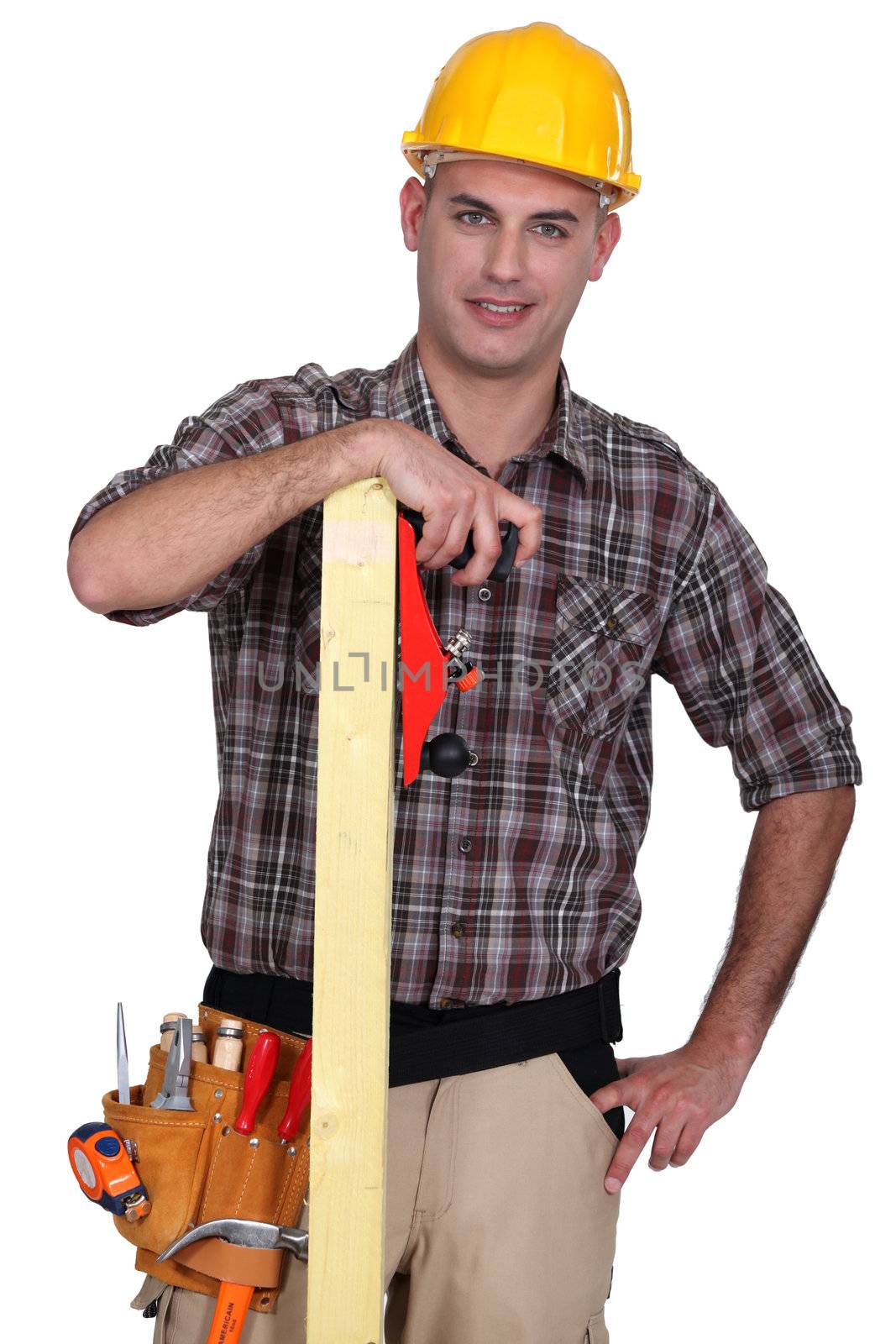 craftsman holding a wooden board