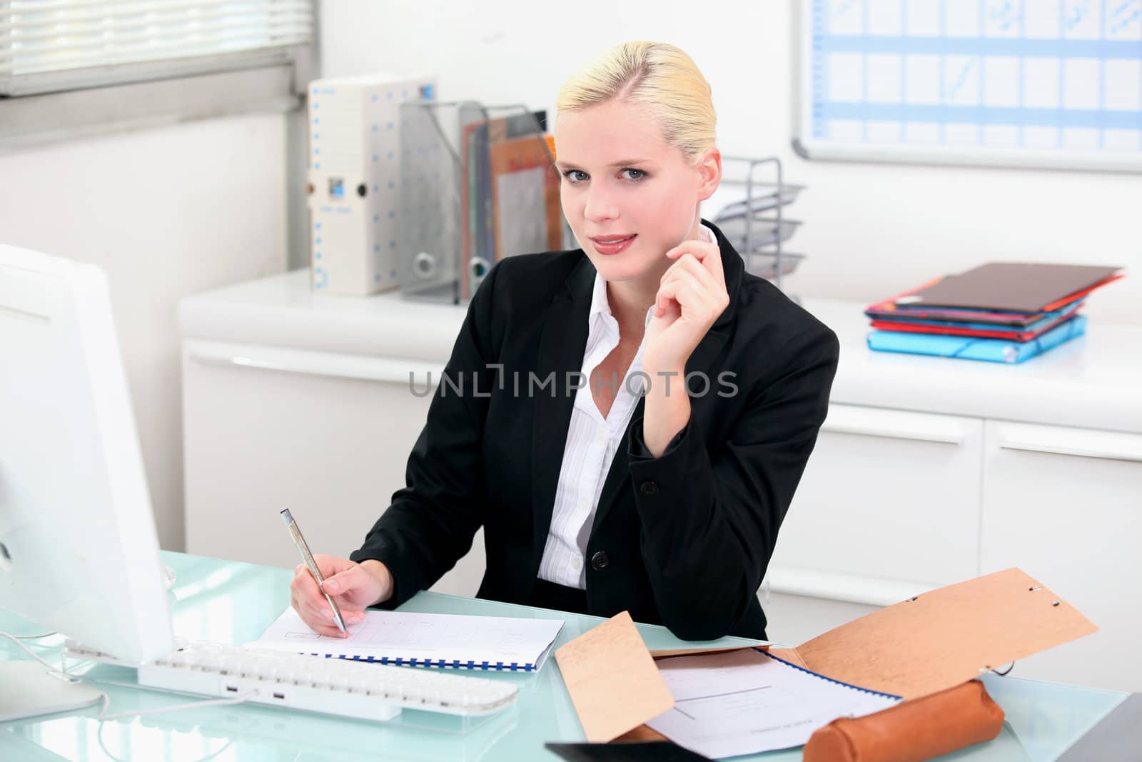 Blonde woman working at her desk