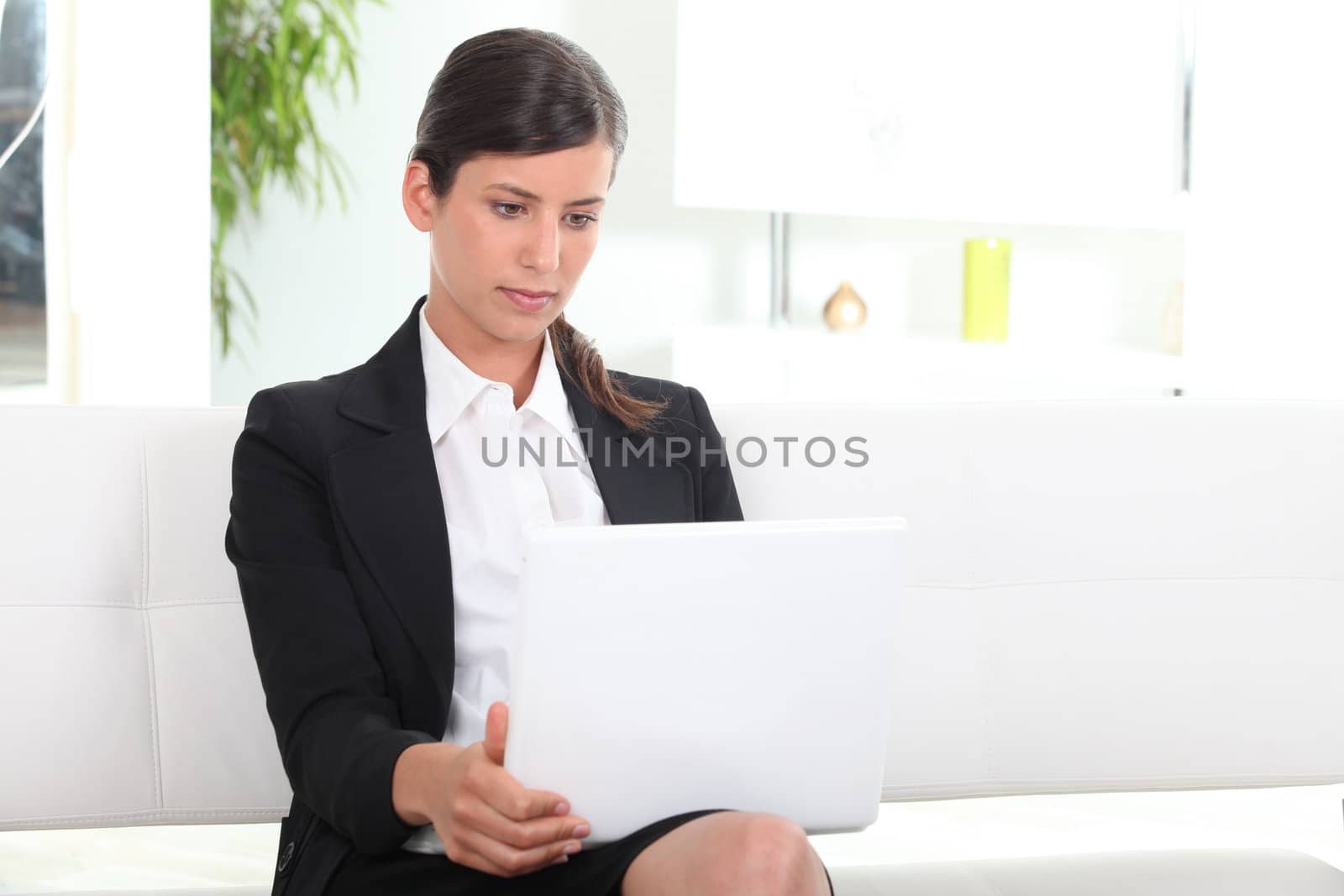 Businesswoman using laptop in office