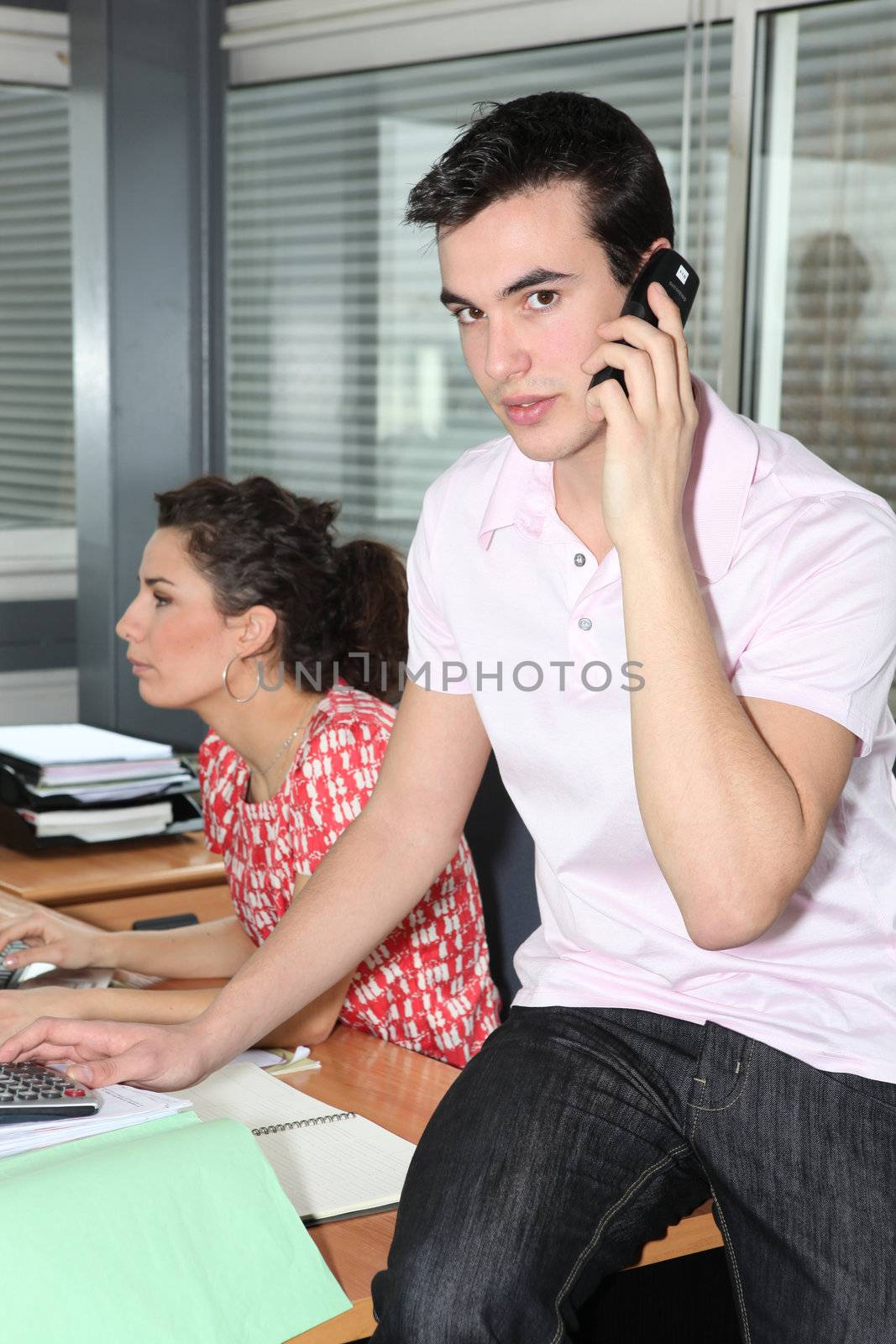 Young workers in office by phovoir