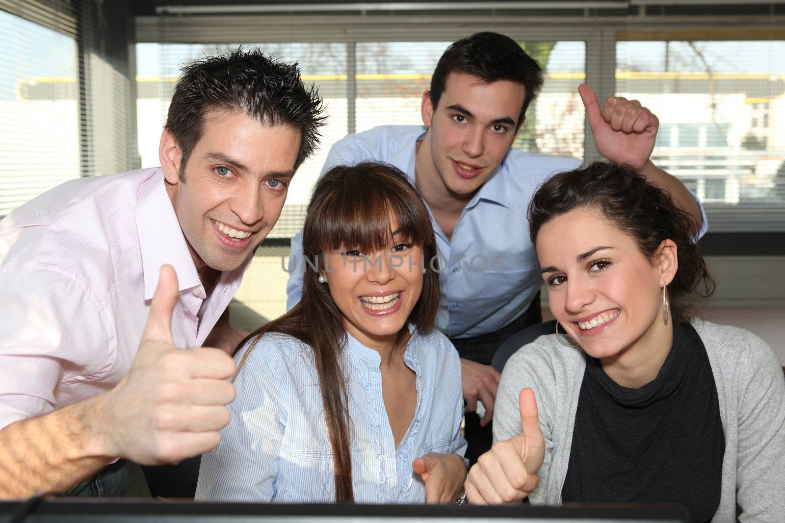 Office workers giving a thumbs up
