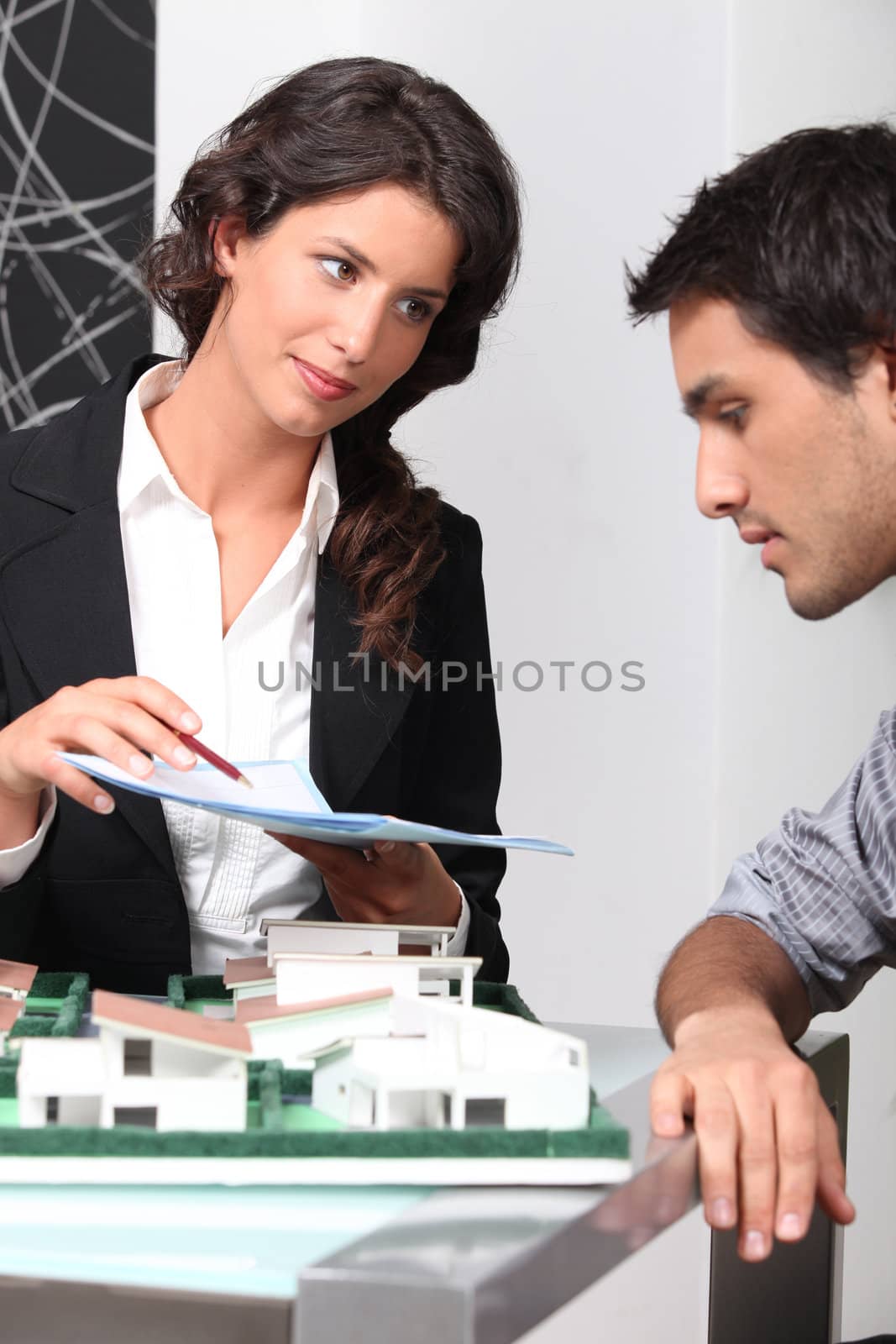 Estate agent and client discussing contracts
