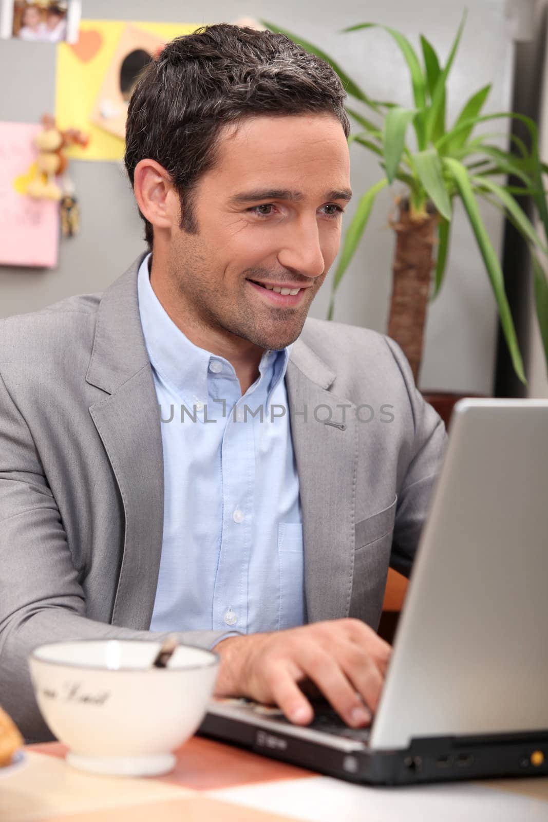 Man using his laptop during breakfast