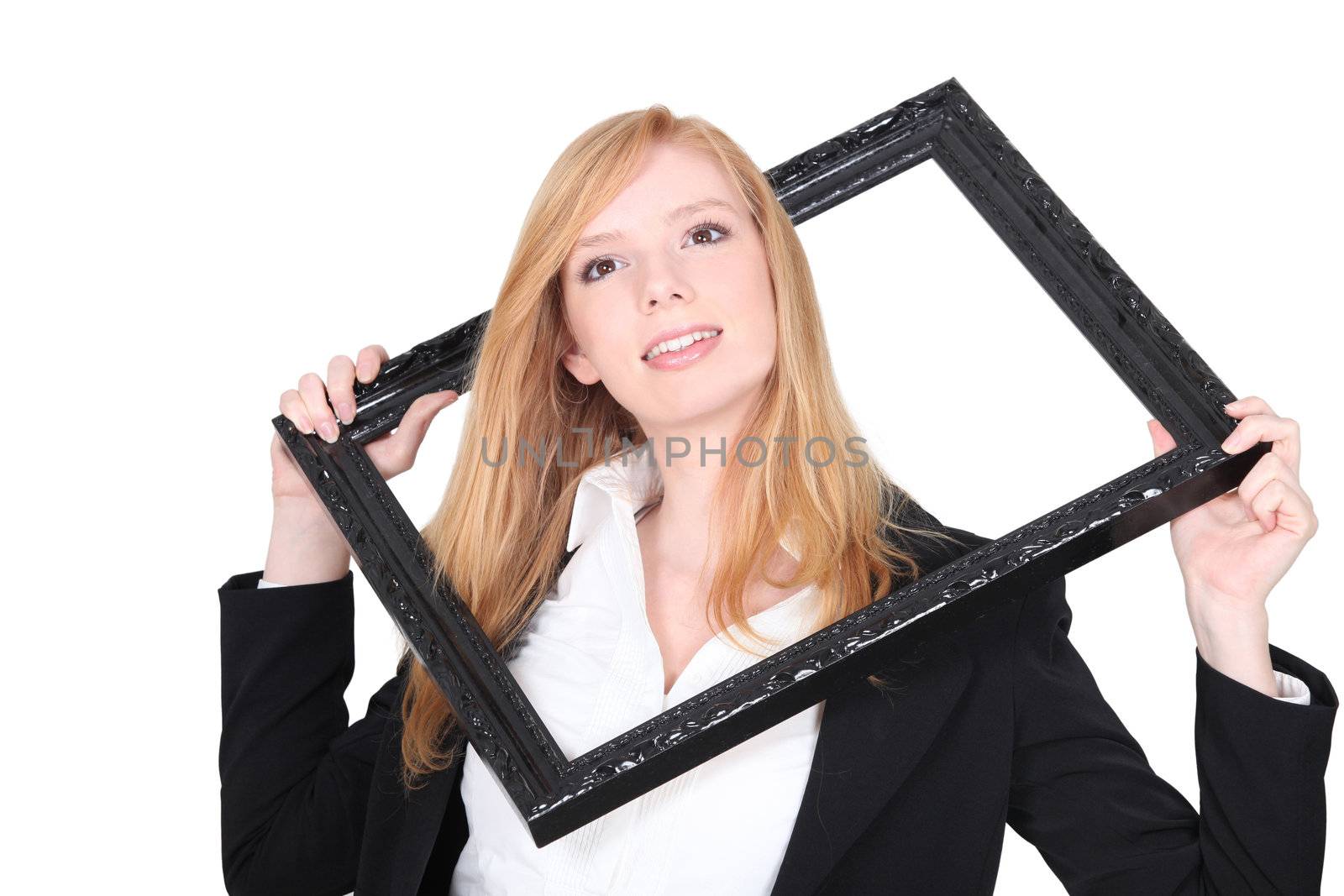 Girl passing her head through a frame