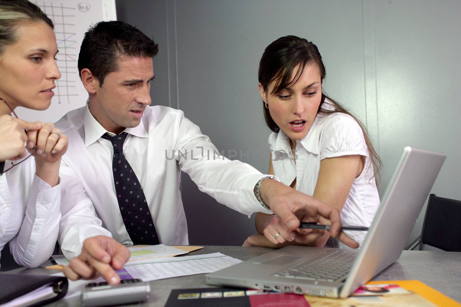 Disgusted businesspeople looking at marketing results by phovoir