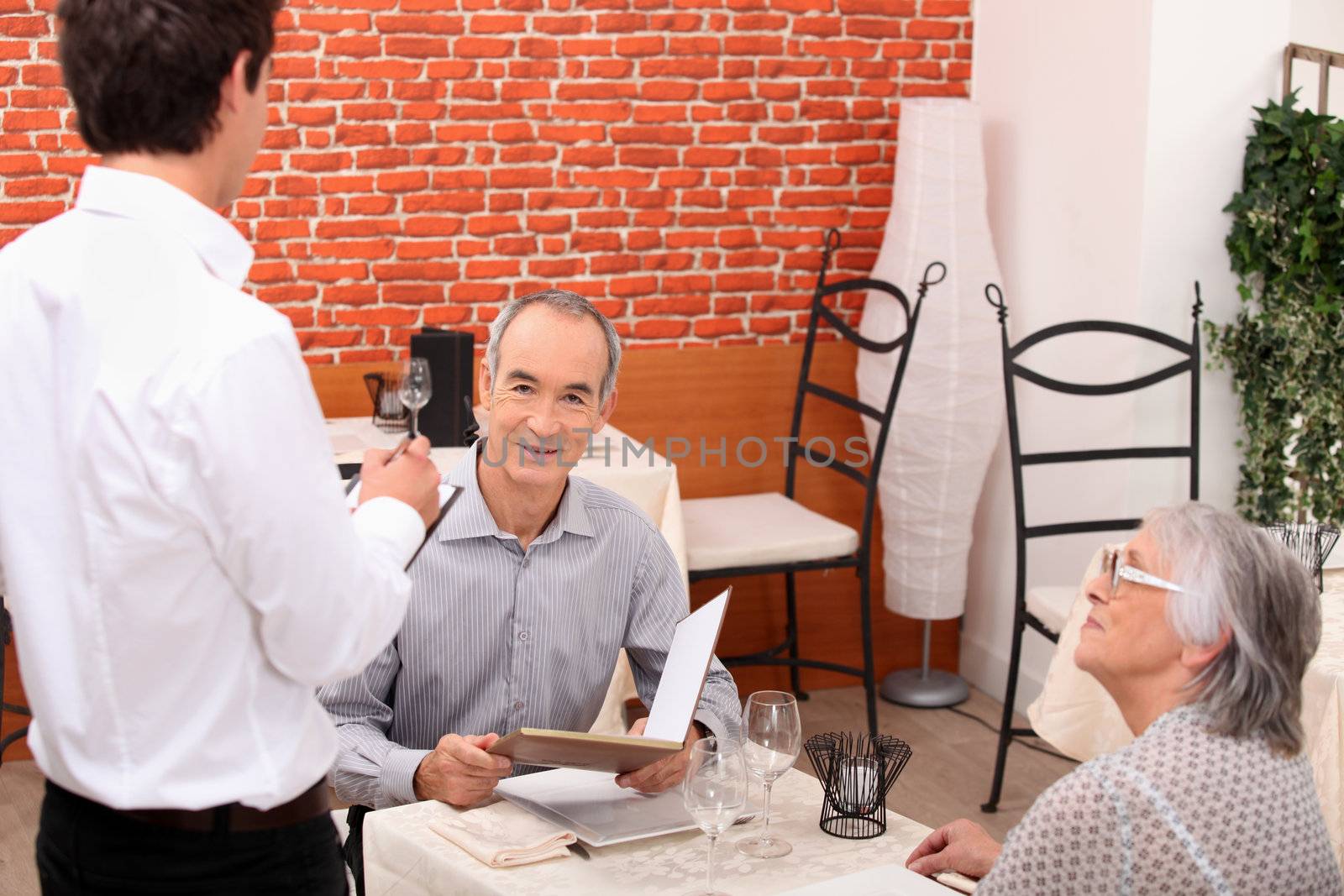 Waiter taking an order by phovoir