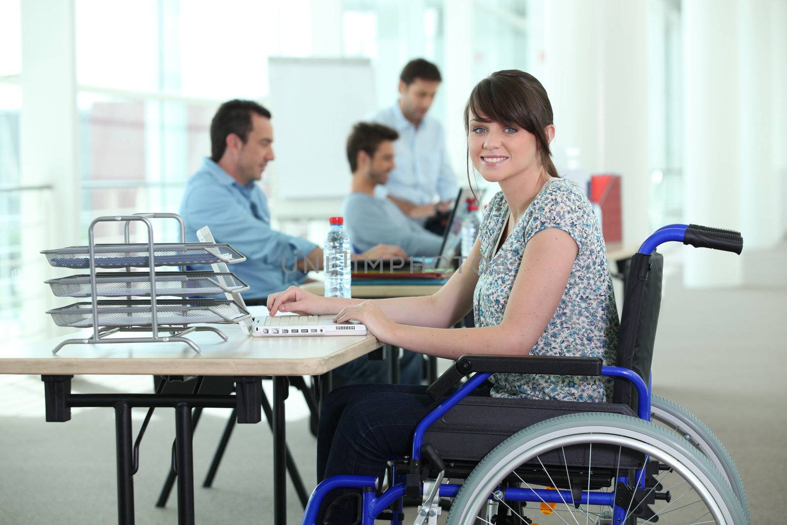 Woman in wheelchair with laptop computer