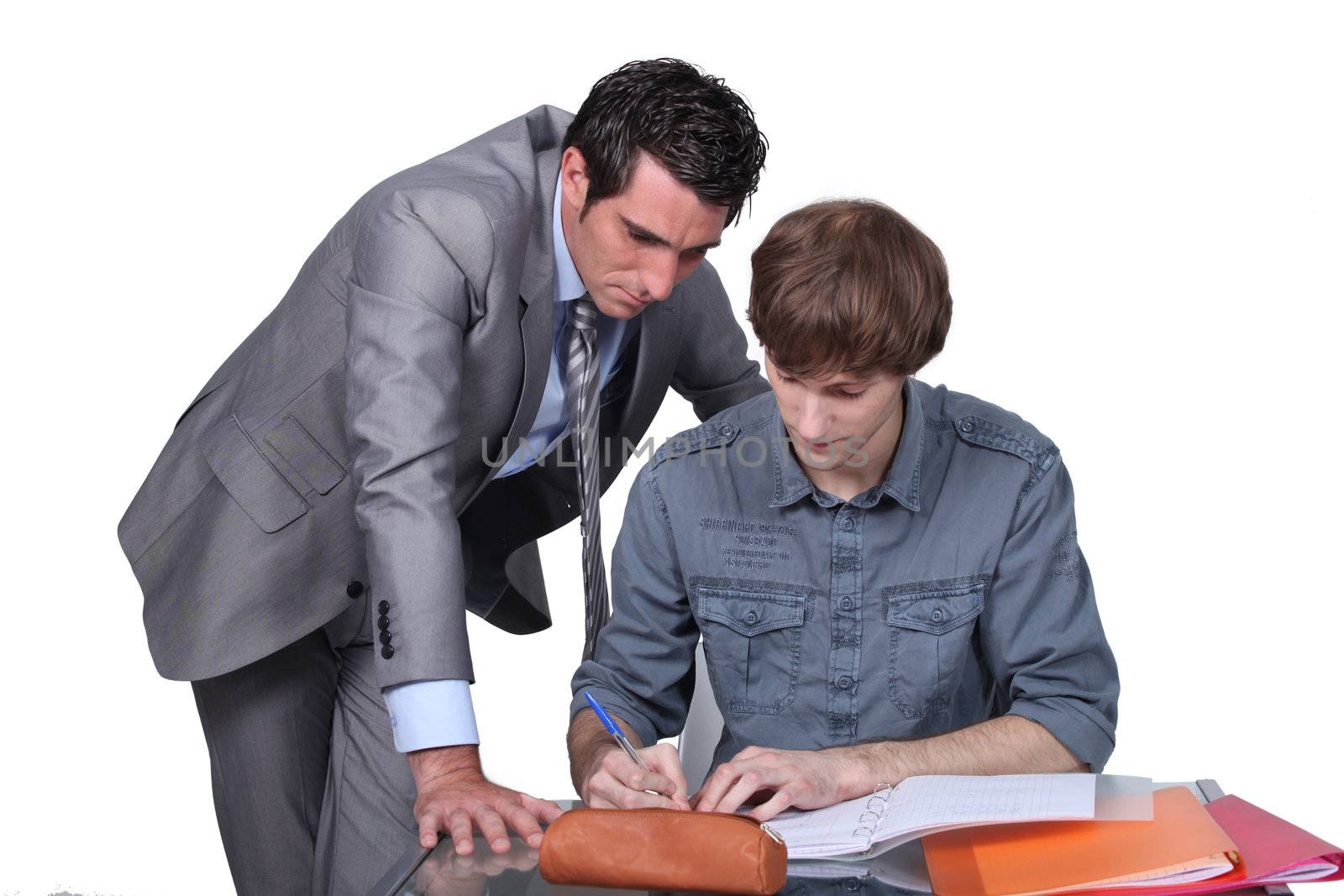 Teacher helping a student with his studies