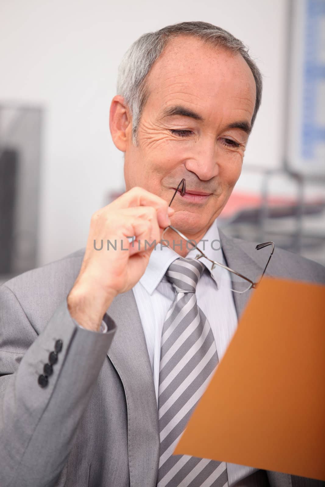 Senior businessman relaxing at desk