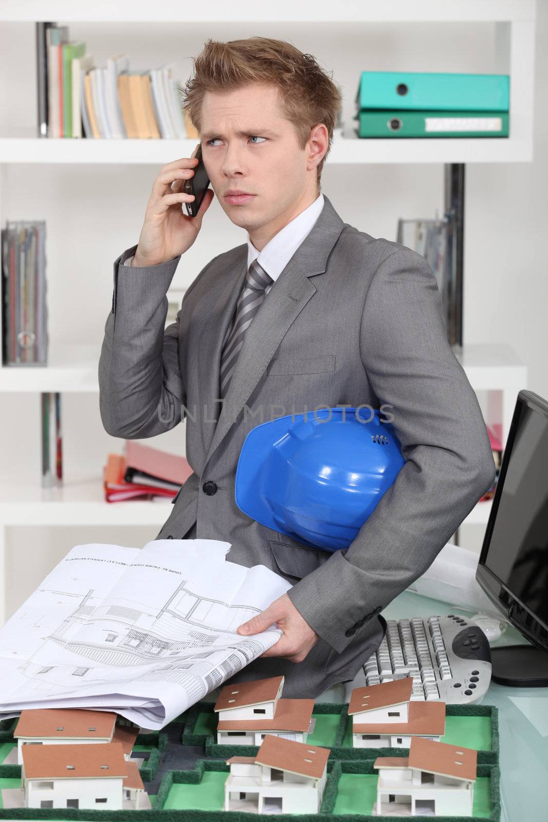 An annoyed architect talking on the phone