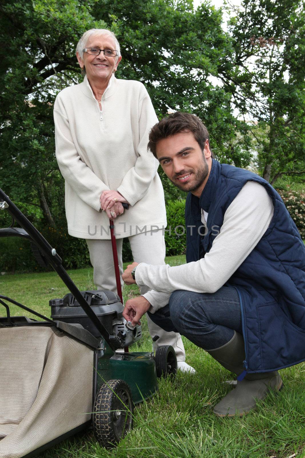 Senior with gardener and lawnmower