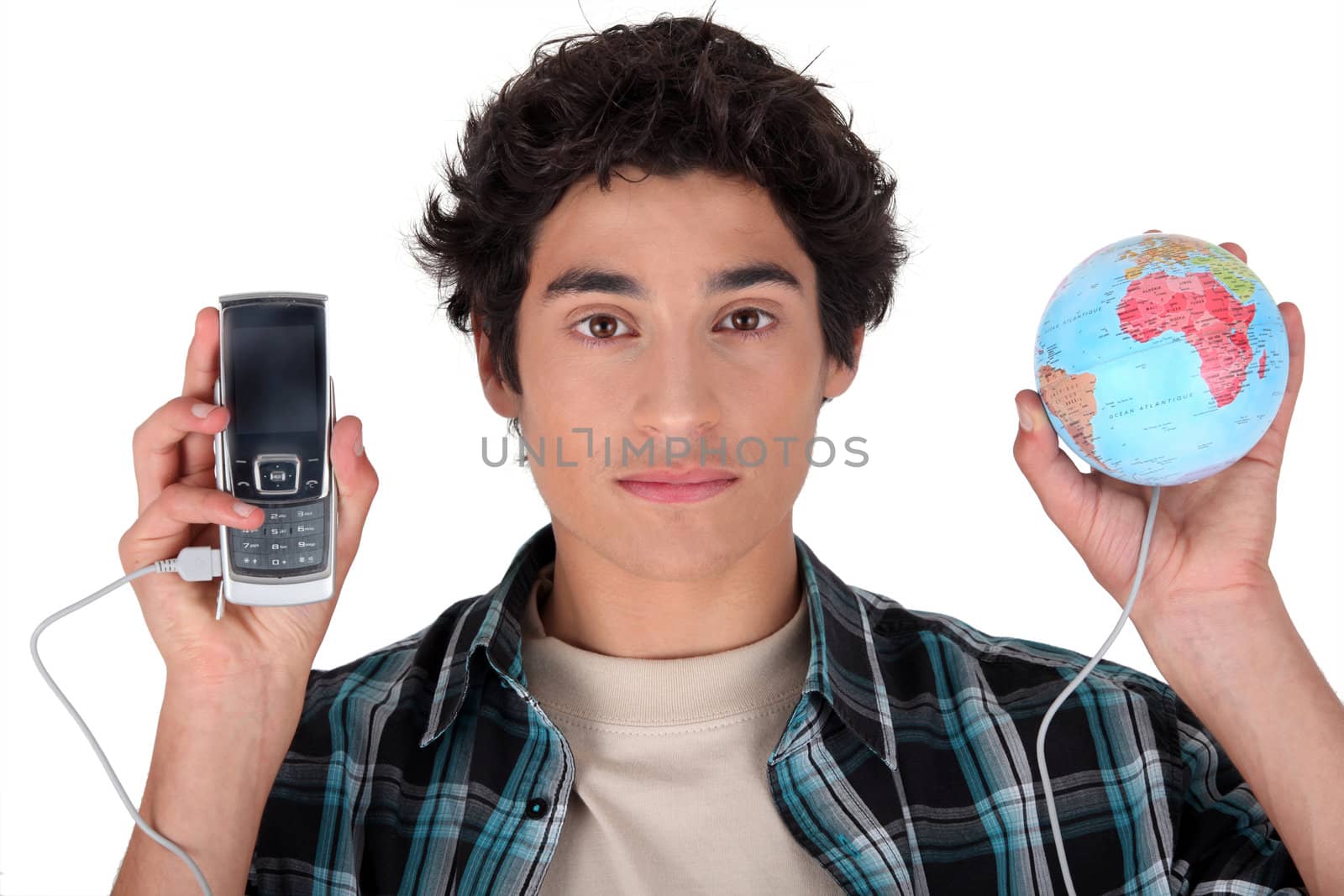 a teenage boy connecting a cell phone and a globe