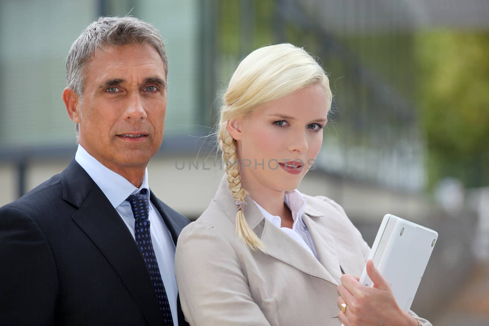 Business couple standing outside