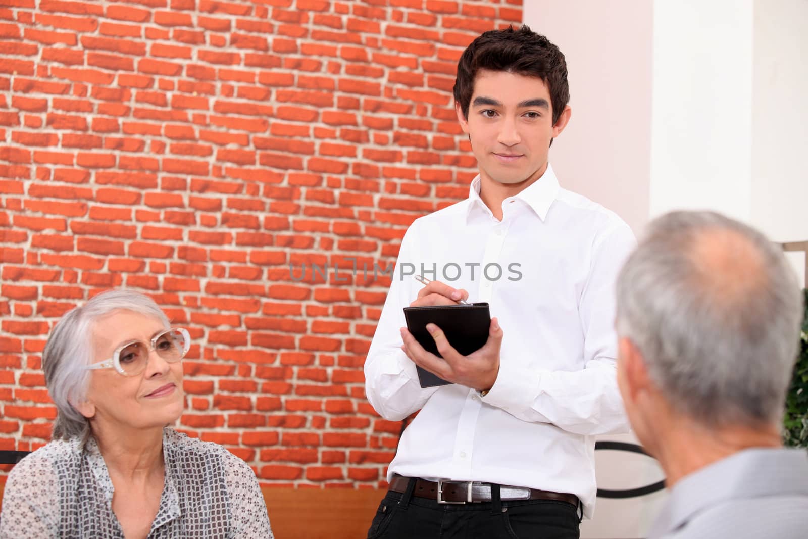 waiter in restaurant taking order